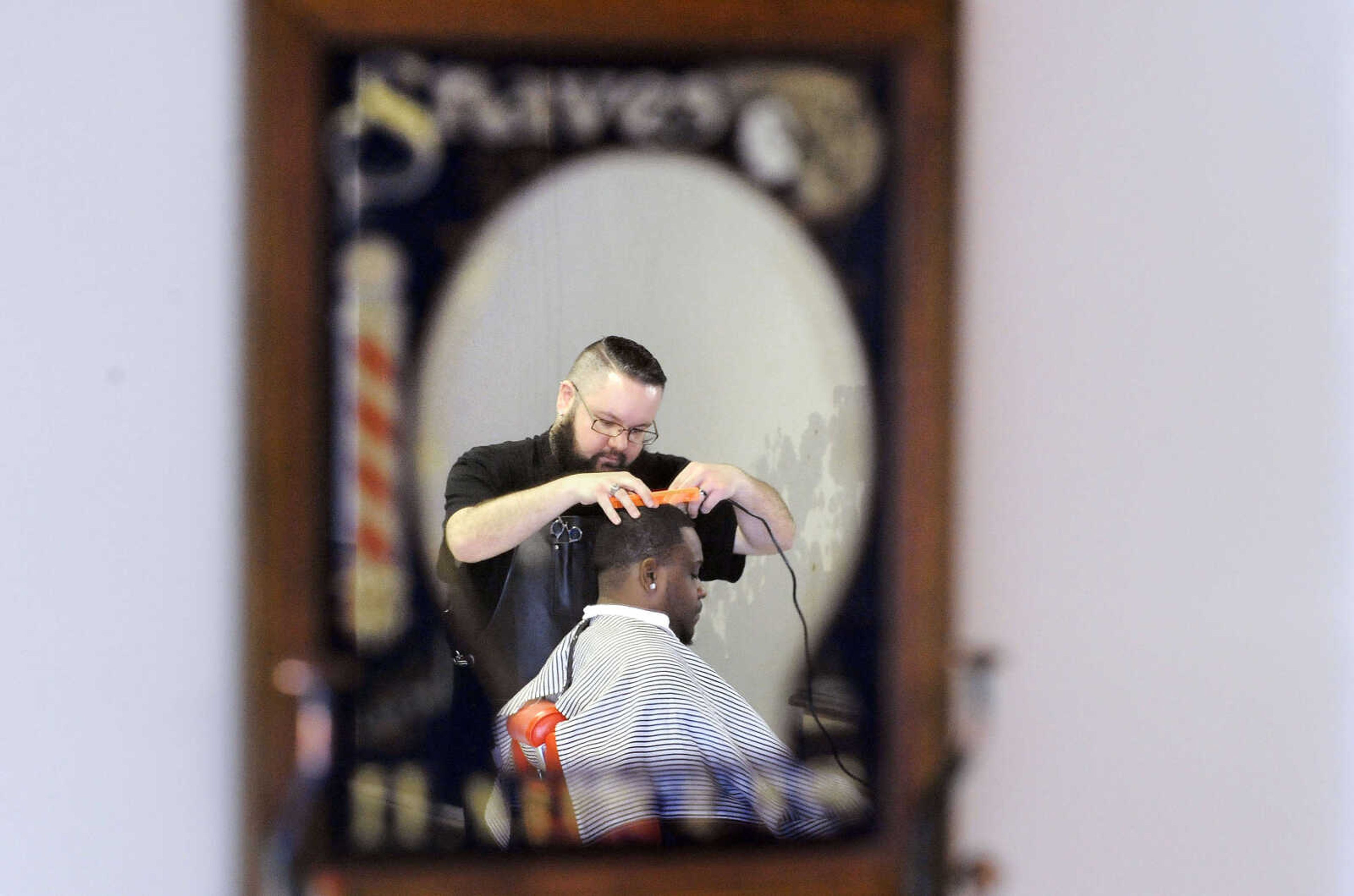 LAURA SIMON ~ lsimon@semissourian.com

Dru Booth, owner of Oddfellows Barbershop in downtown Sikeston, works on a client on Tuesday, March 15, 2016.