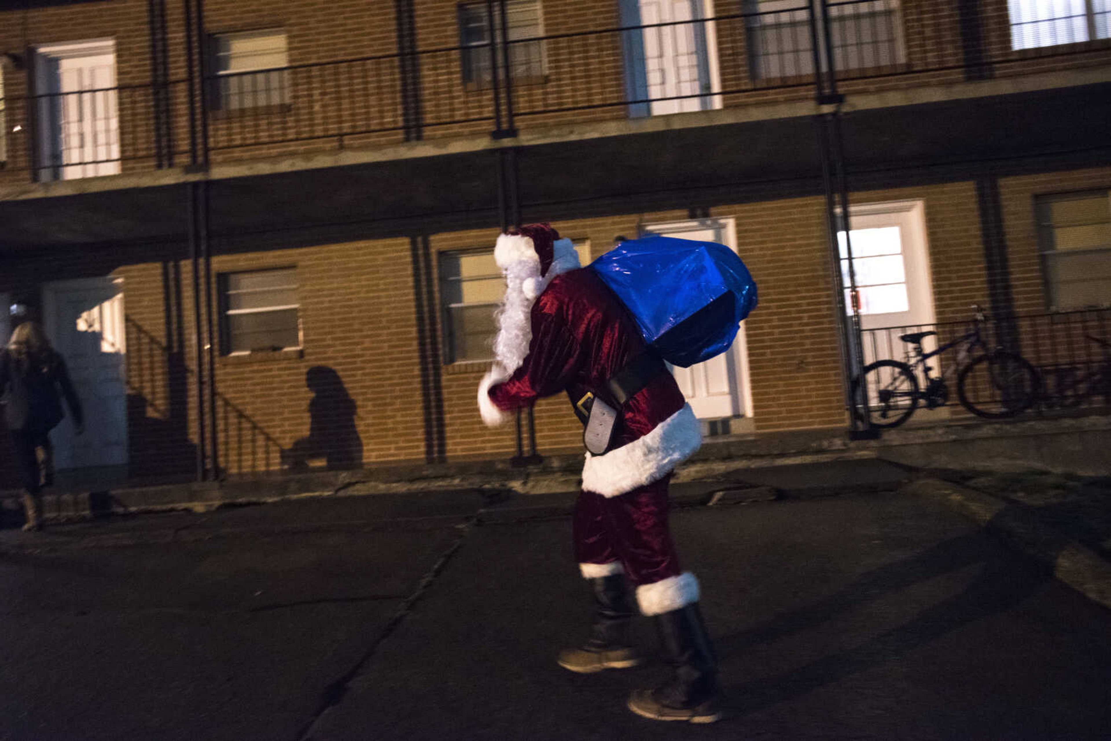 Charlie Wirtle as Santa deliveries presents to kids during the Jaycee Toybox delivery on Thursday, Dec. 22, 2016, in Cape Girardeau.