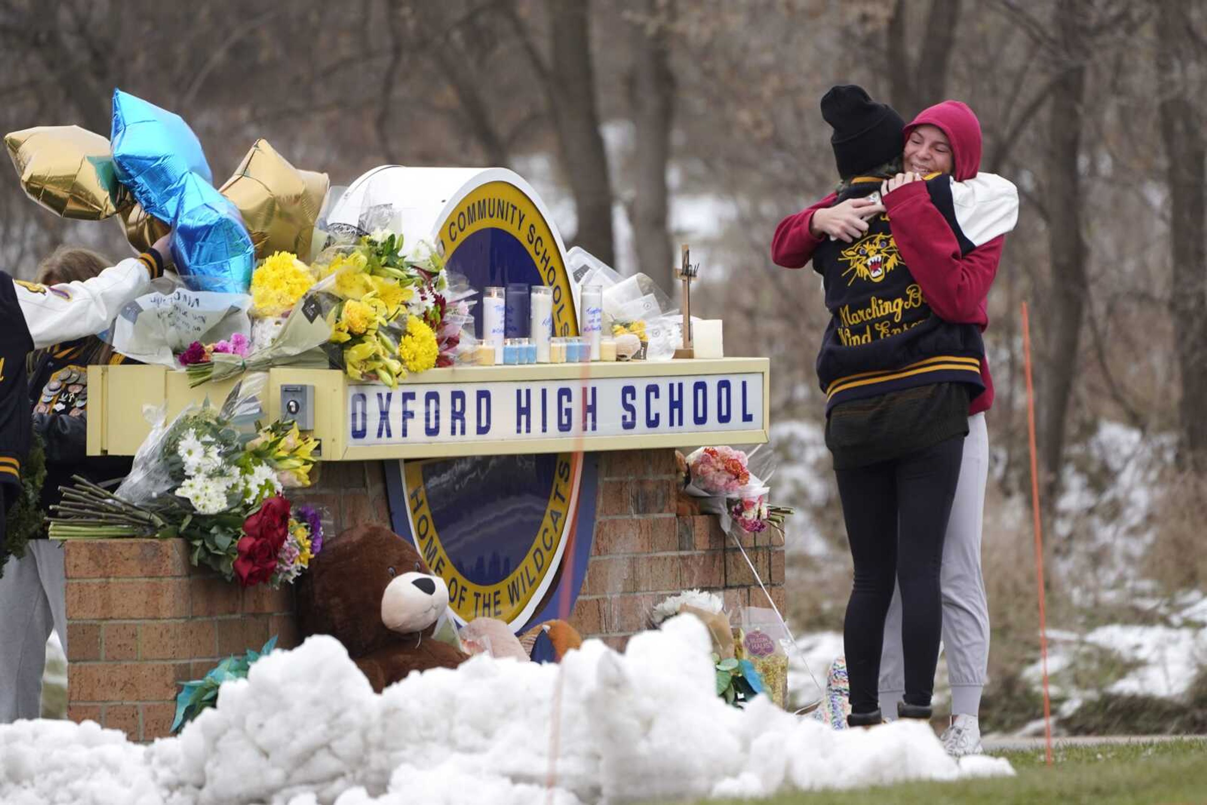 Students hug at a memorial at Oxford High School on Wednesday in Oxford, Michigan.