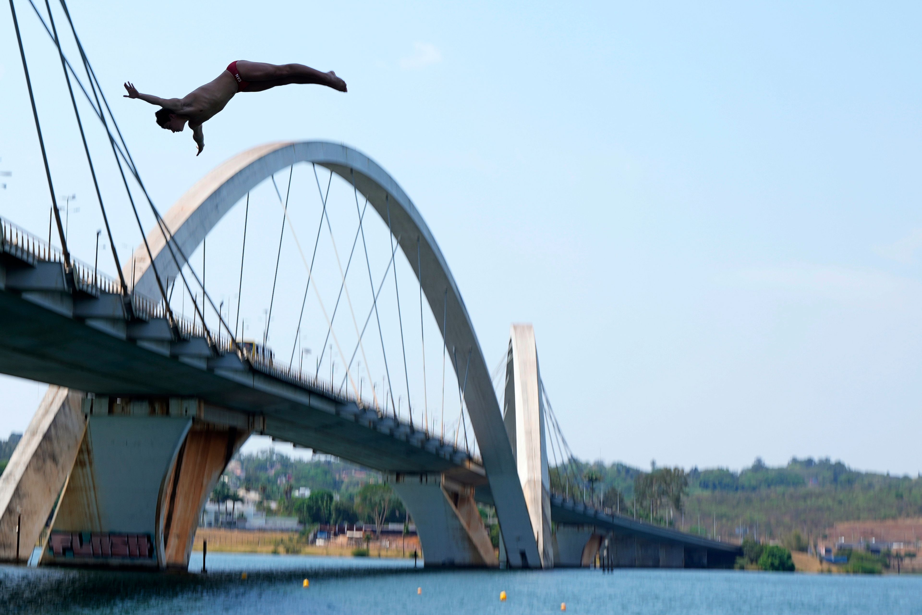 Canada's Alex Tiaglei competes at the World Aquatics High Diving Junior Championships by the JK Bridge in Brasilia, Brazil, Oct. 11, 2024. (AP Photo/Eraldo Peres)