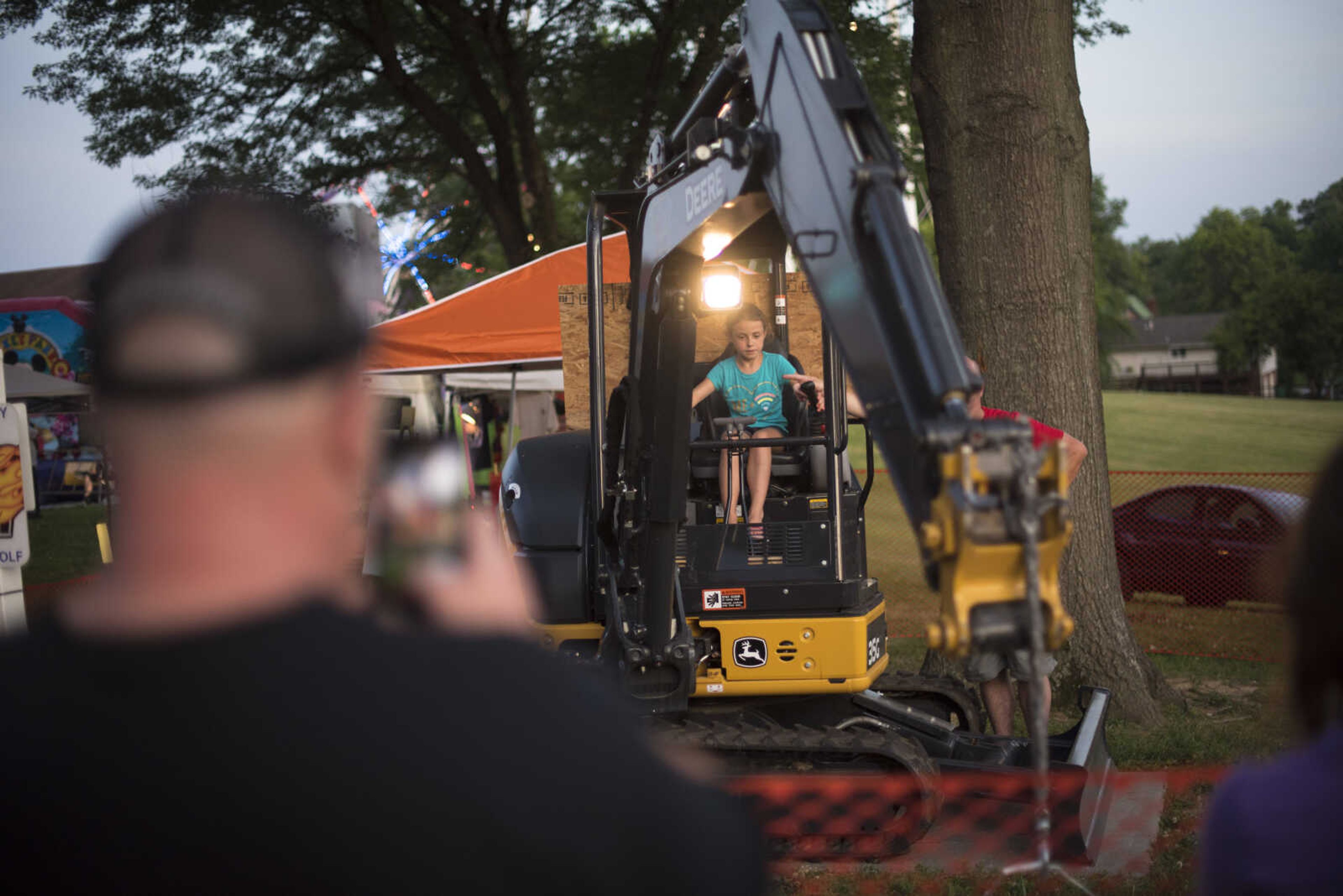 Karissa Atchley, 9, controls a crane during the 41st annual Mid-Summer Festival Saturday, June 17, 2017 at Scott City Park.