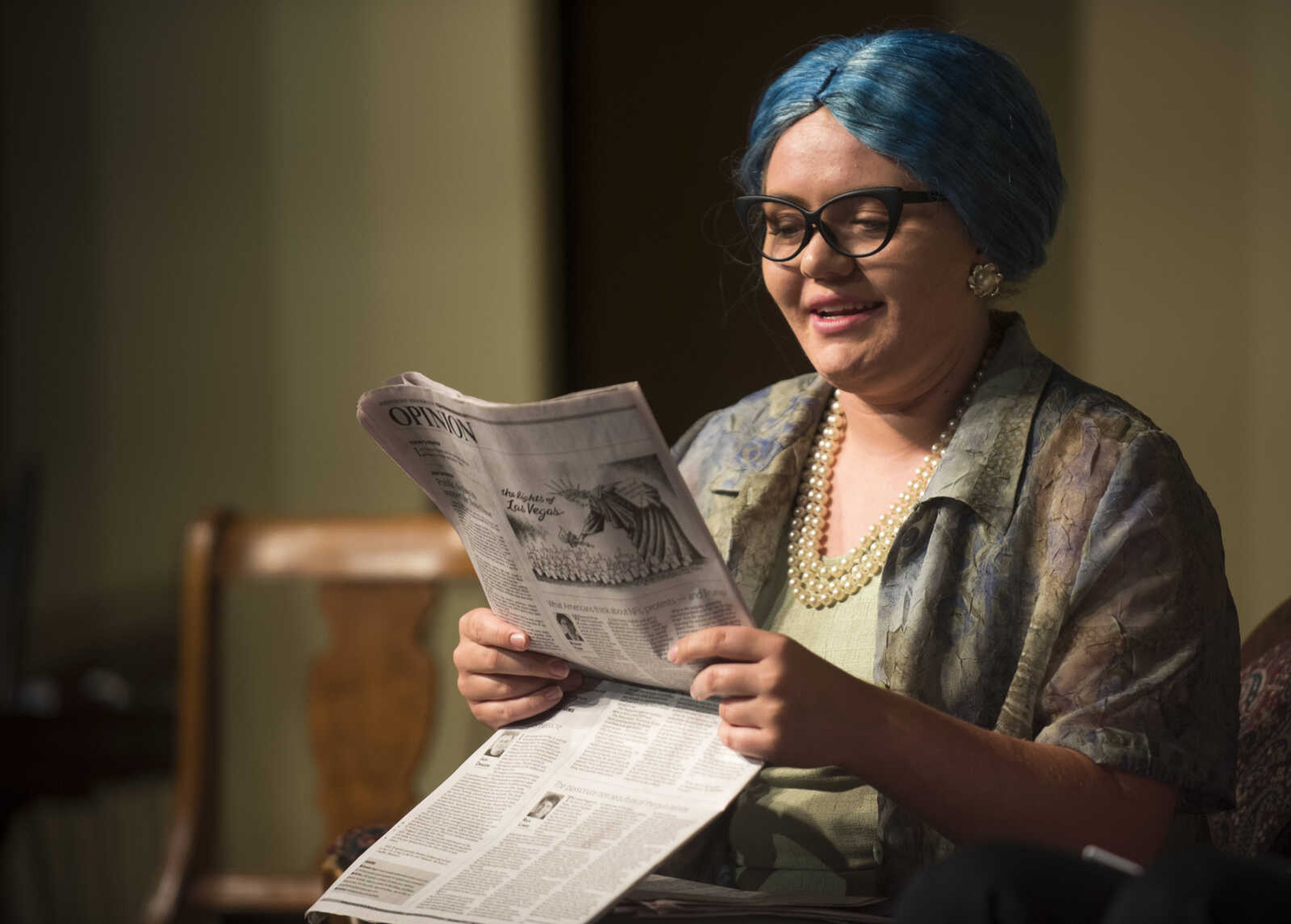 Ethel Savage, played by Madison Dowdy, reads about her family in the newspaper during a scene in a dress rehearsal for Jackson's fall play, "The Curious Savage" Oct. 10, 2017 at Jackson High School.