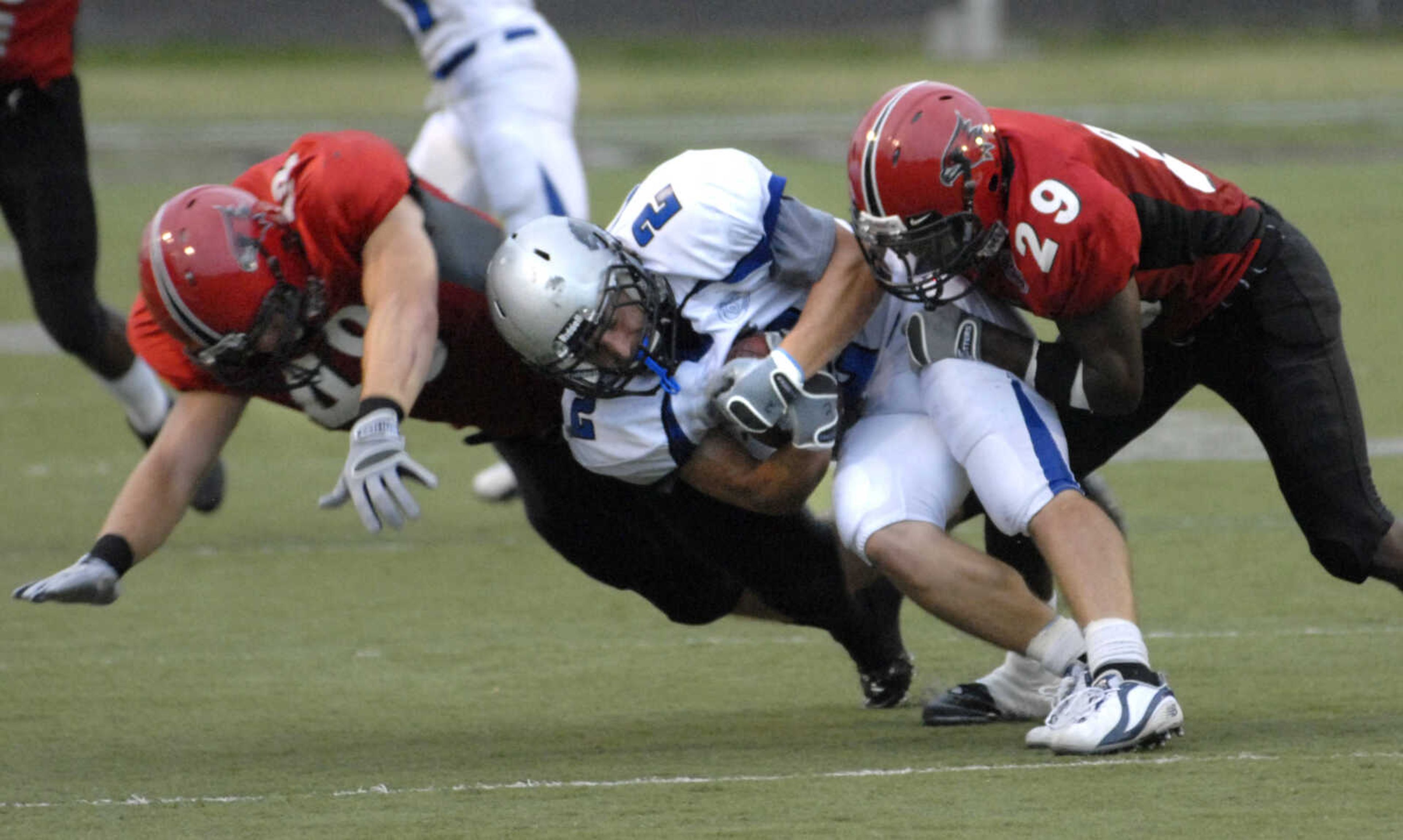 FRED LYNCH ~ flynch@semissourian.com
Southeast Missouri State defenders Philip Klaproth, left, and Salim Powell tackle Eastern Illinois running back Jimmy Potempa during the first quarter Saturday at Houck Stadium.