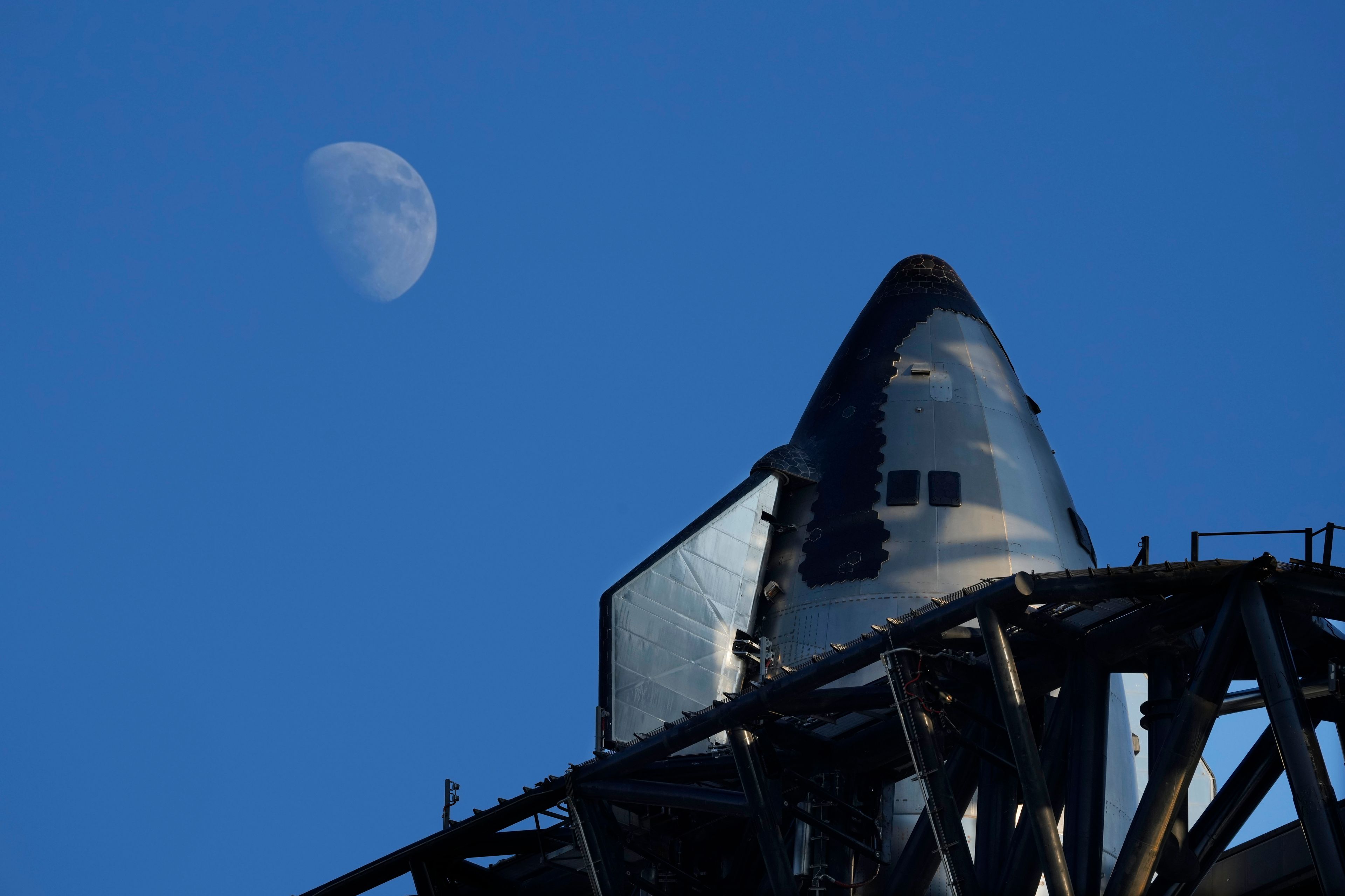 The moon rises over SpaceX's mega rocket Starship as it is prepares for a test launch Saturday, Oct. 12, 2024, in Boca Chica, Texas. (AP Photo/Eric Gay)