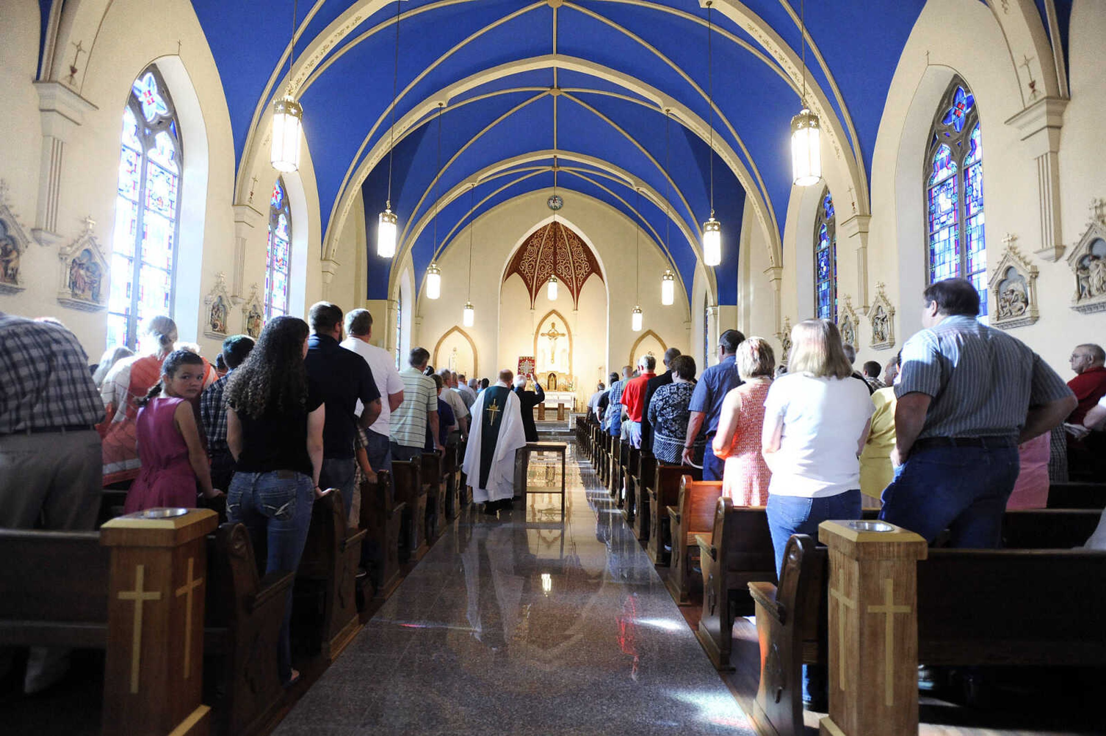 LAURA SIMON ~ lsimon@semissourian.com

Parishioners stand as Rev. David Coon walks down the aisle during the opening procession of the first mass inside the newly remodeled St. John's Catholic Church in Leopold, Missouri on Sunday, May 29, 2016.