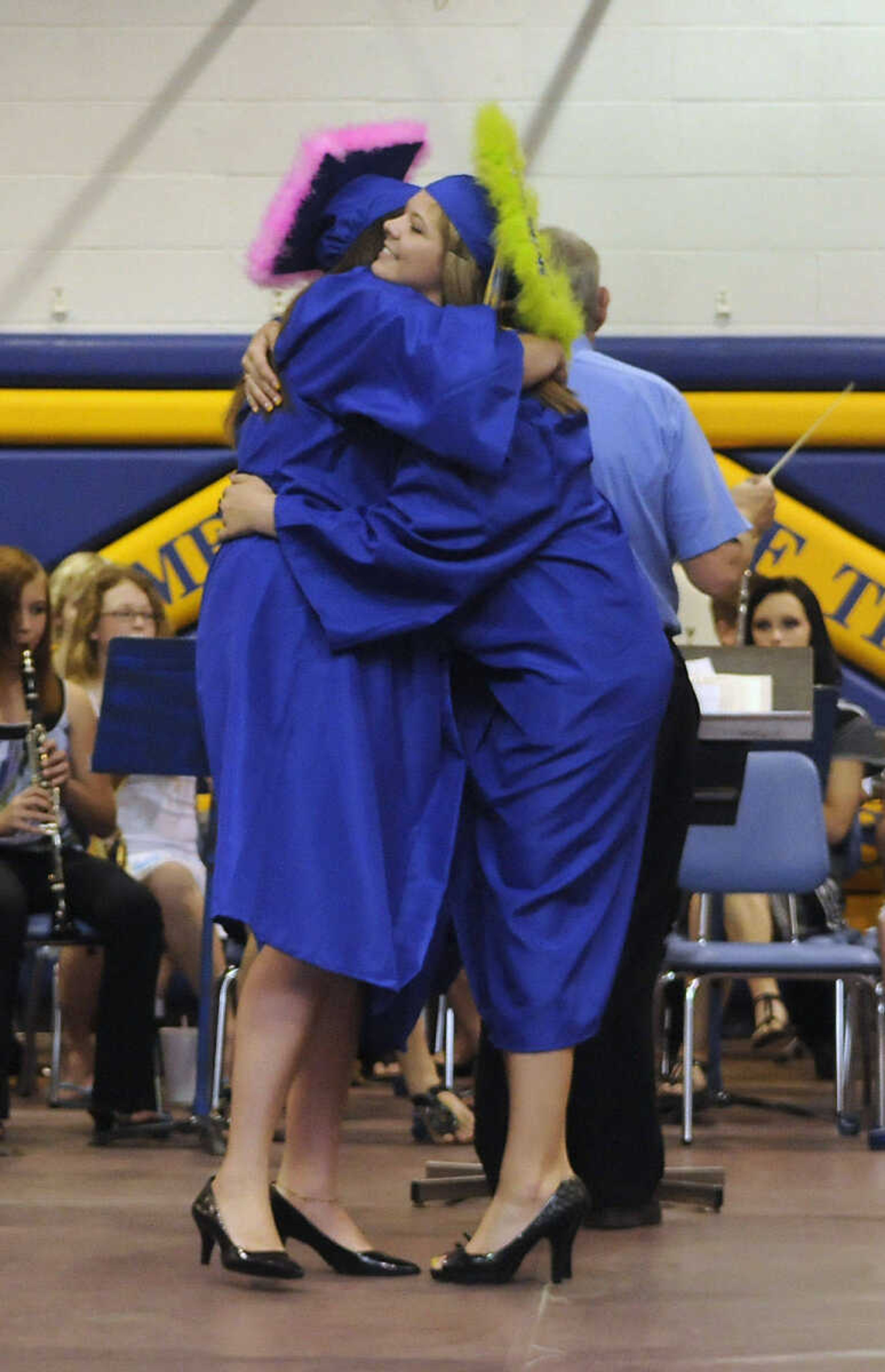 KRISTIN EBERTS ~ keberts@semissourian.com

Samantha Stevens, left, and Emily Wright hug before walking to their seats during the processional march at Scott City High School's 2010 Commencement in the school gym on Sunday, May 23.