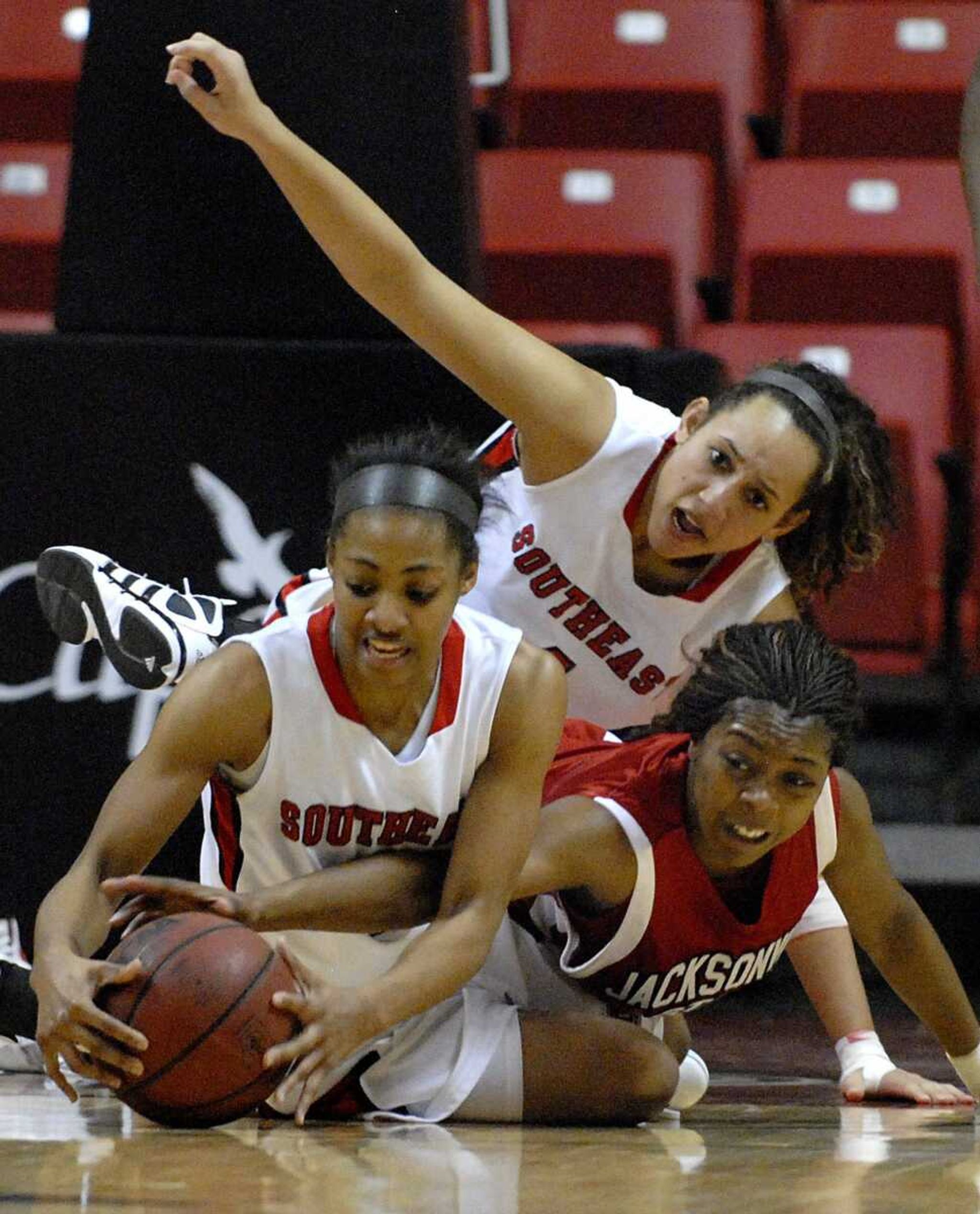 Southeast Missouri State's Bianca Beck, left, Brittany Harriel and Jacksonville State's Candace Morton dive for a loose ball during the second half of a game on Monday, Jan. 2, 2012, at the Show Me Center. Southeast won 66-48. (Kristin Eberts)