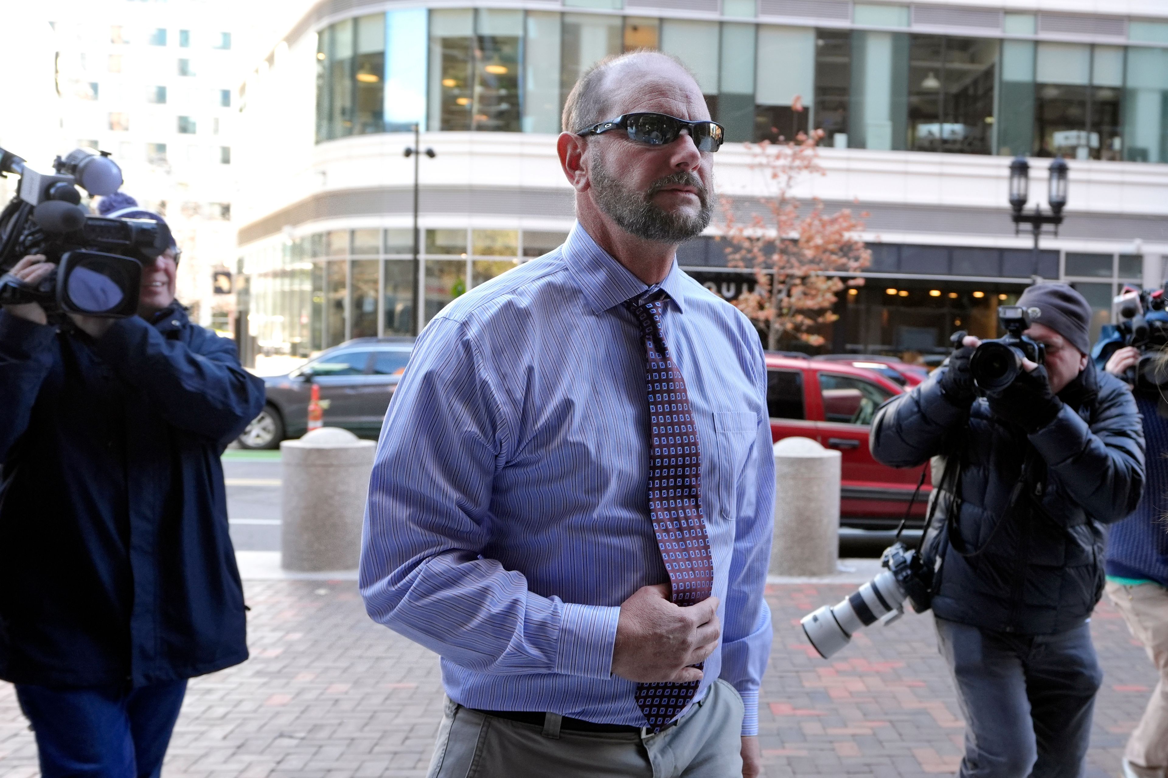 Jack Michael Teixeira, center, father of Massachusetts Air National Guardsman Jack Teixeira. arrives at federal court for his son's sentencing hearing, Tuesday, Nov. 12, 2024, in Boston,. (AP Photo/Steven Senne)