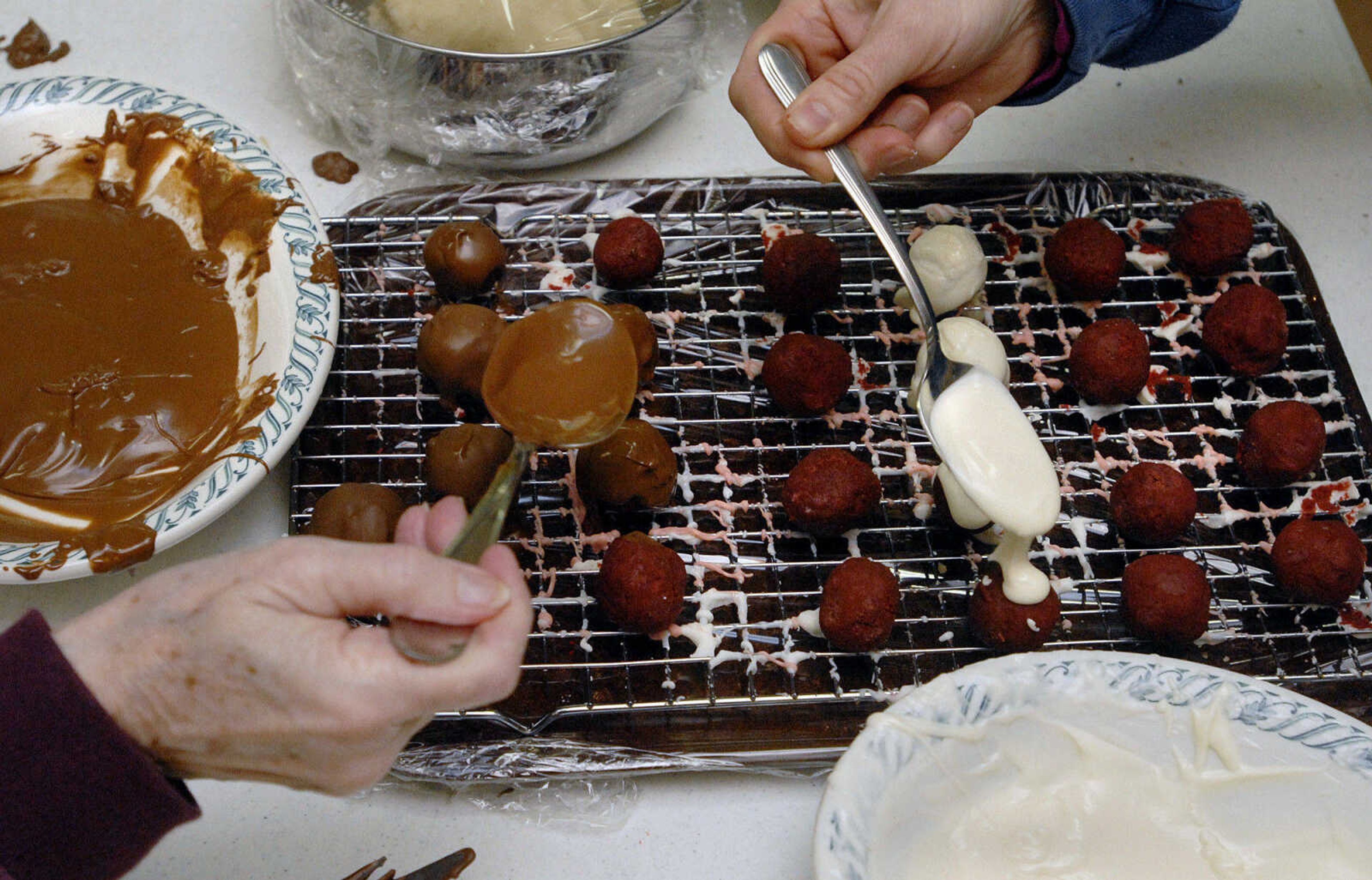 LAURA SIMON~lsimon@semissourian.com
Chocolate is carefully drizzled over red velvet cake balls coating them in yummy goodness Saturday, February 5, 2011.