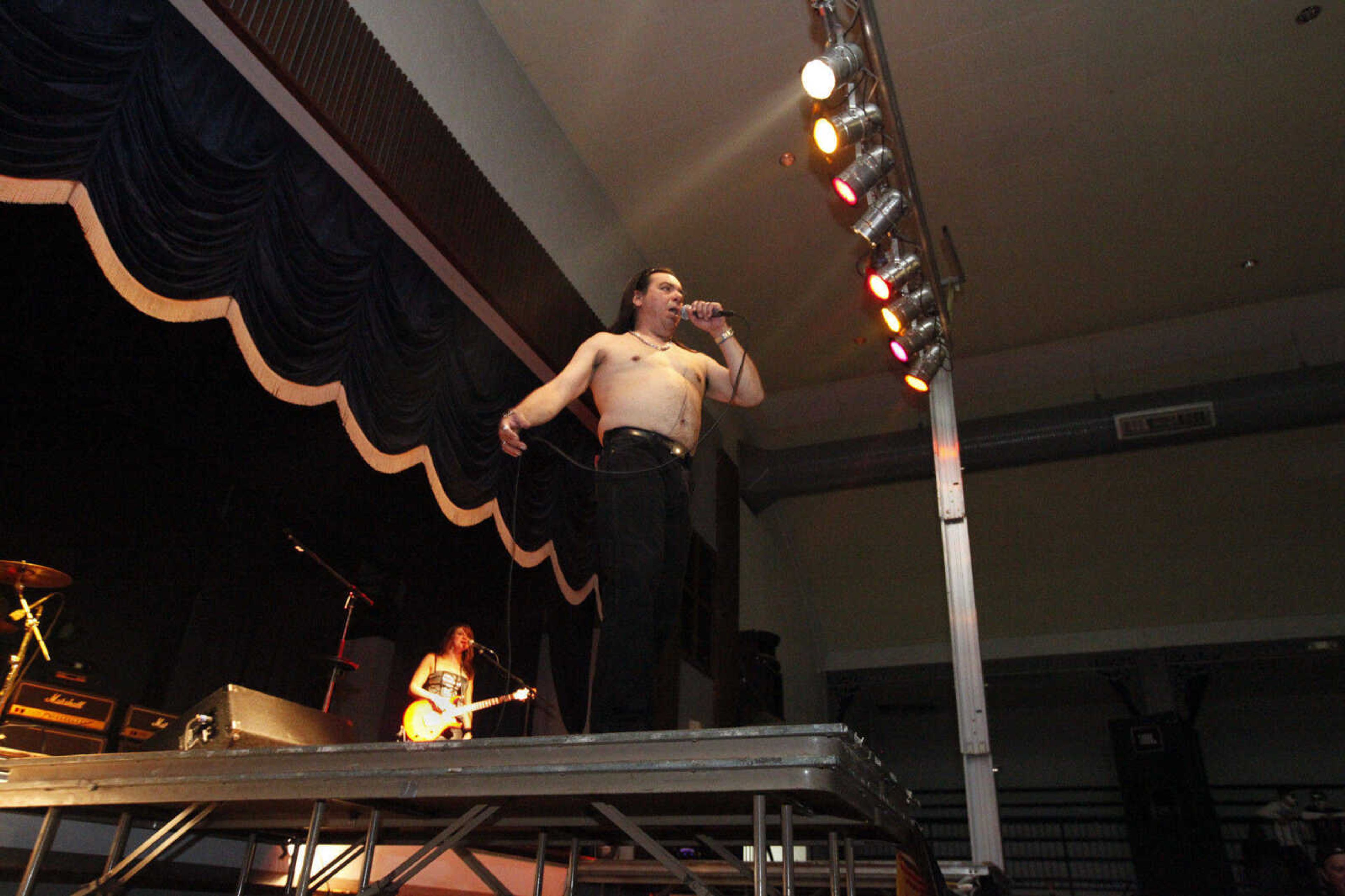 CHRIS MACKLER ~ photos@semissourian.com

Singer David Llano and guitarist Colleen Gonzalez of Dirty Deeds, a tribute to AC/DC, perform during the Kiss, AC/DC and Rod Stewart Tribute Concert held at the Arena Building on Saturday, Nov. 6, 2010, in Cape Girardeau.