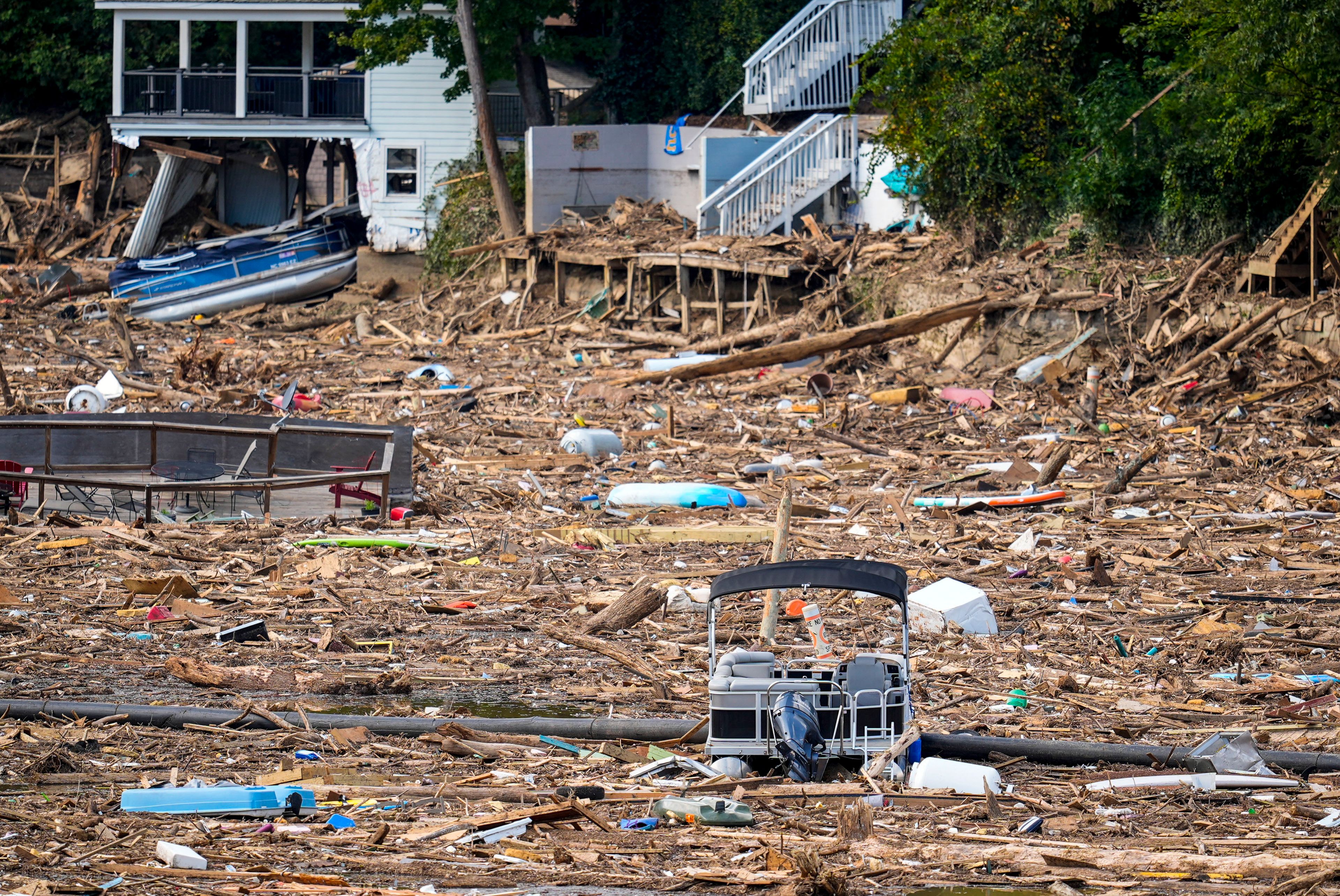 Debris is strewn on the lake in the aftermath of Hurricane Helene, Wednesday, Oct. 2, 2024, in Lake Lure, N.C. (AP Photo/Mike Stewart)