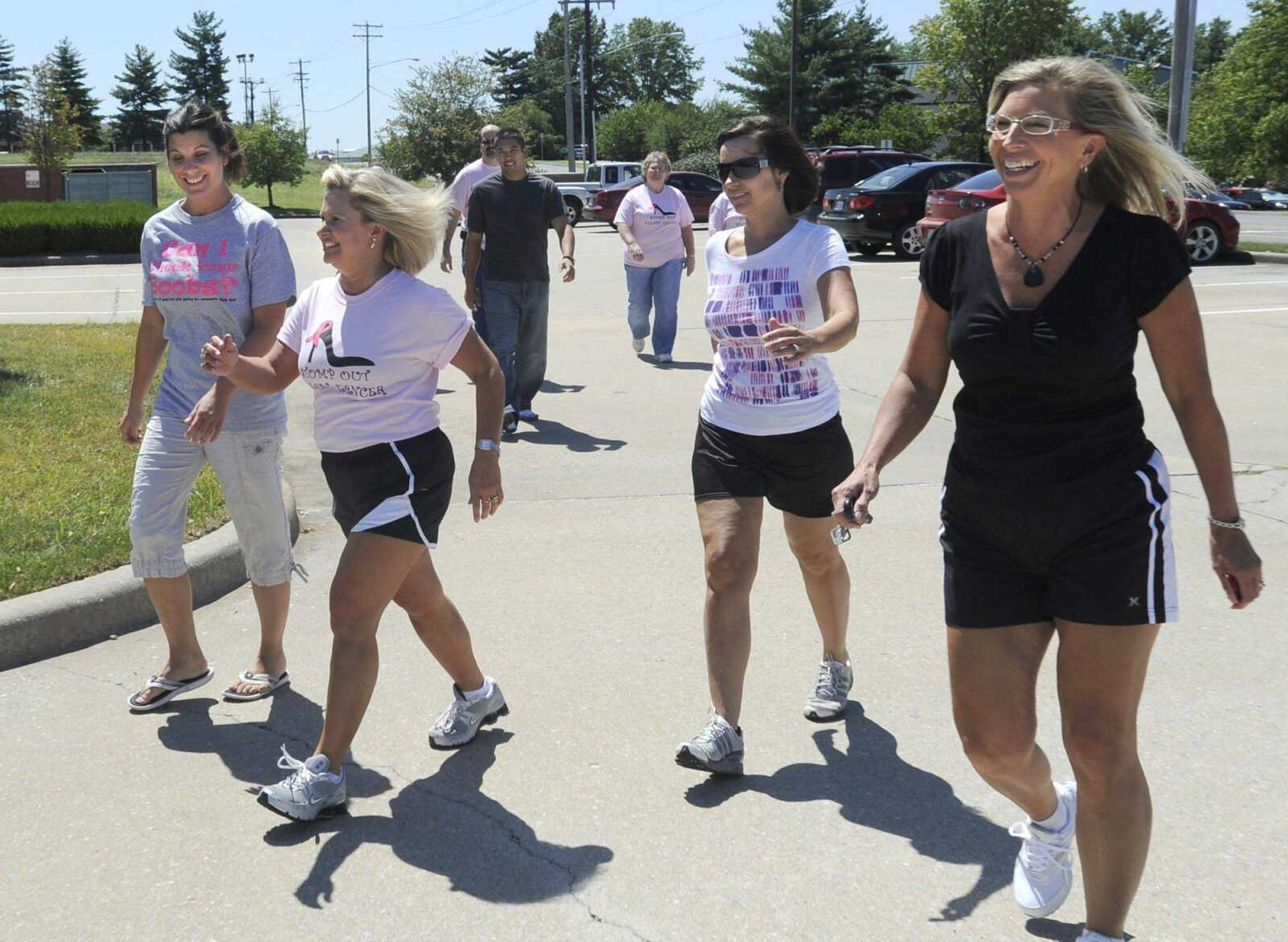 Holly Team members, from left, Crystal Ritter, Teresa Lambert, Juli Cook and Carolyn Essner lead some lunchtime walkers outside MedAssets as they prepare for the 5K Relay for Life Running for the Girls event to be held Saturday. (Fred Lynch)