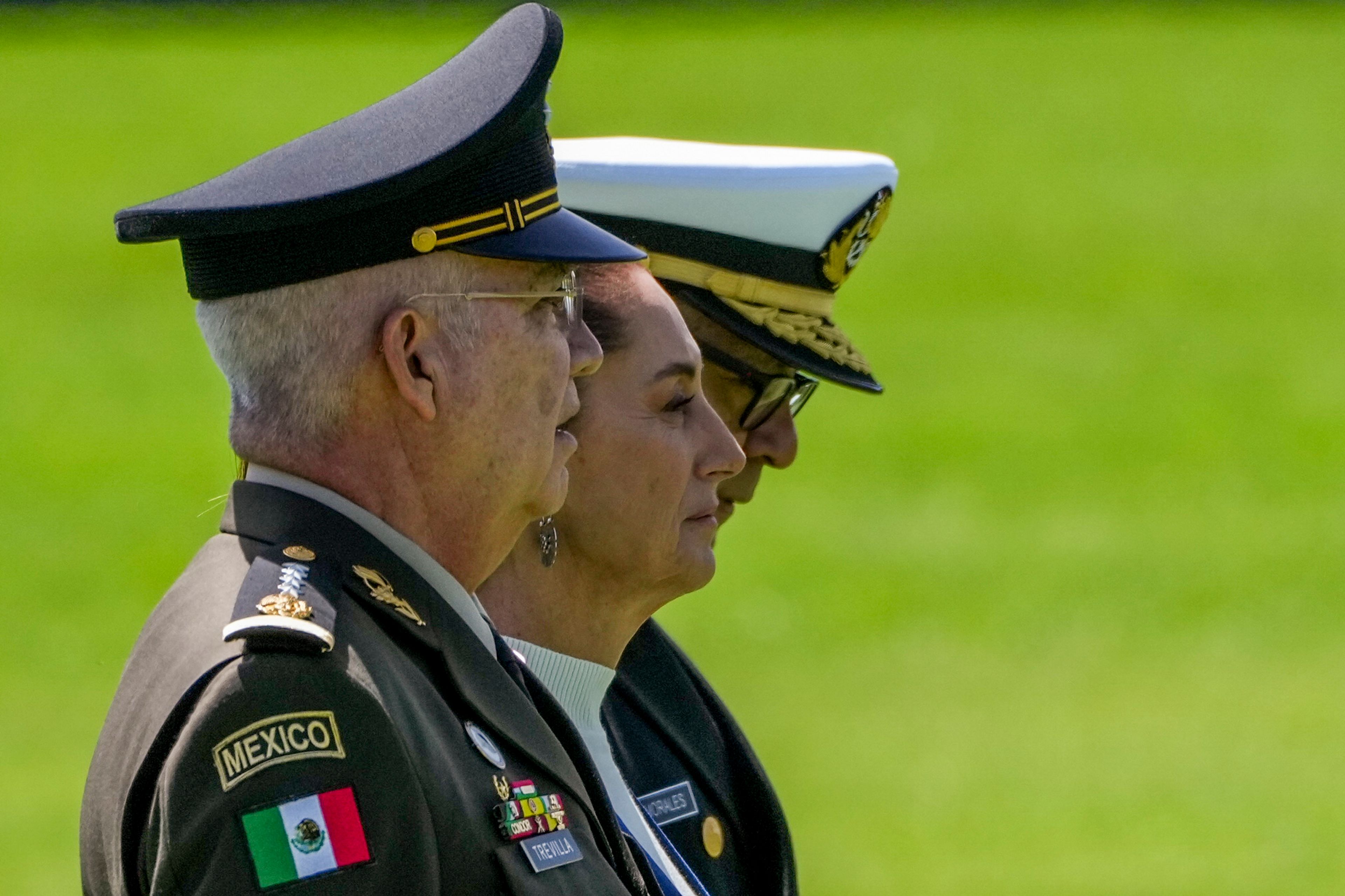 FILE - Mexican President Claudia Sheinbaum, center, reviews the troops with Defense Minister Gen. Ricardo Trevilla Trejo, left, and Navy Secretary Alt. Raymundo Pedro Morales, at Campo Marte in Mexico City, Oct. 3, 2024. (AP Photo/Fernando Llano, File)