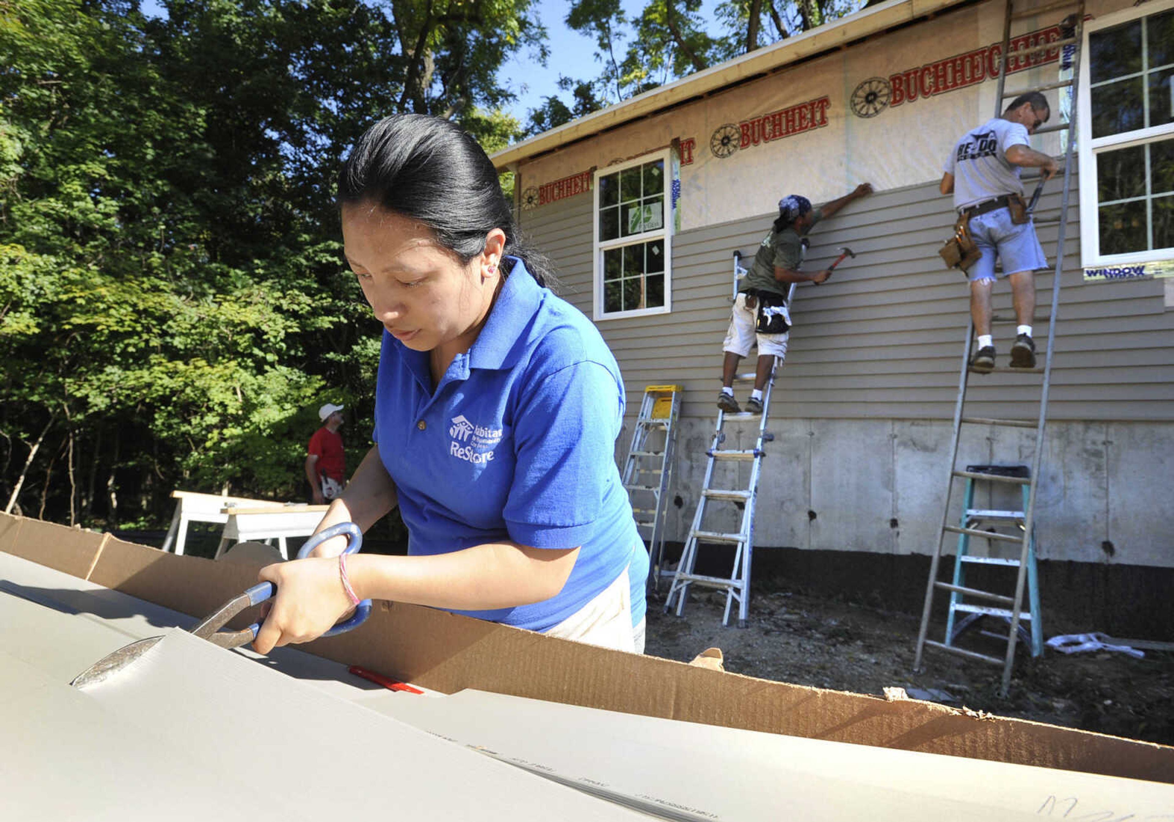 FRED LYNCH ~ flynch@semissourian.com
Preety Pradhan cuts vinyl siding Saturday, Sept. 10, 2016 at a Habitat for Humanity house construction site in Jackson as part of the United Way Days of Caring.