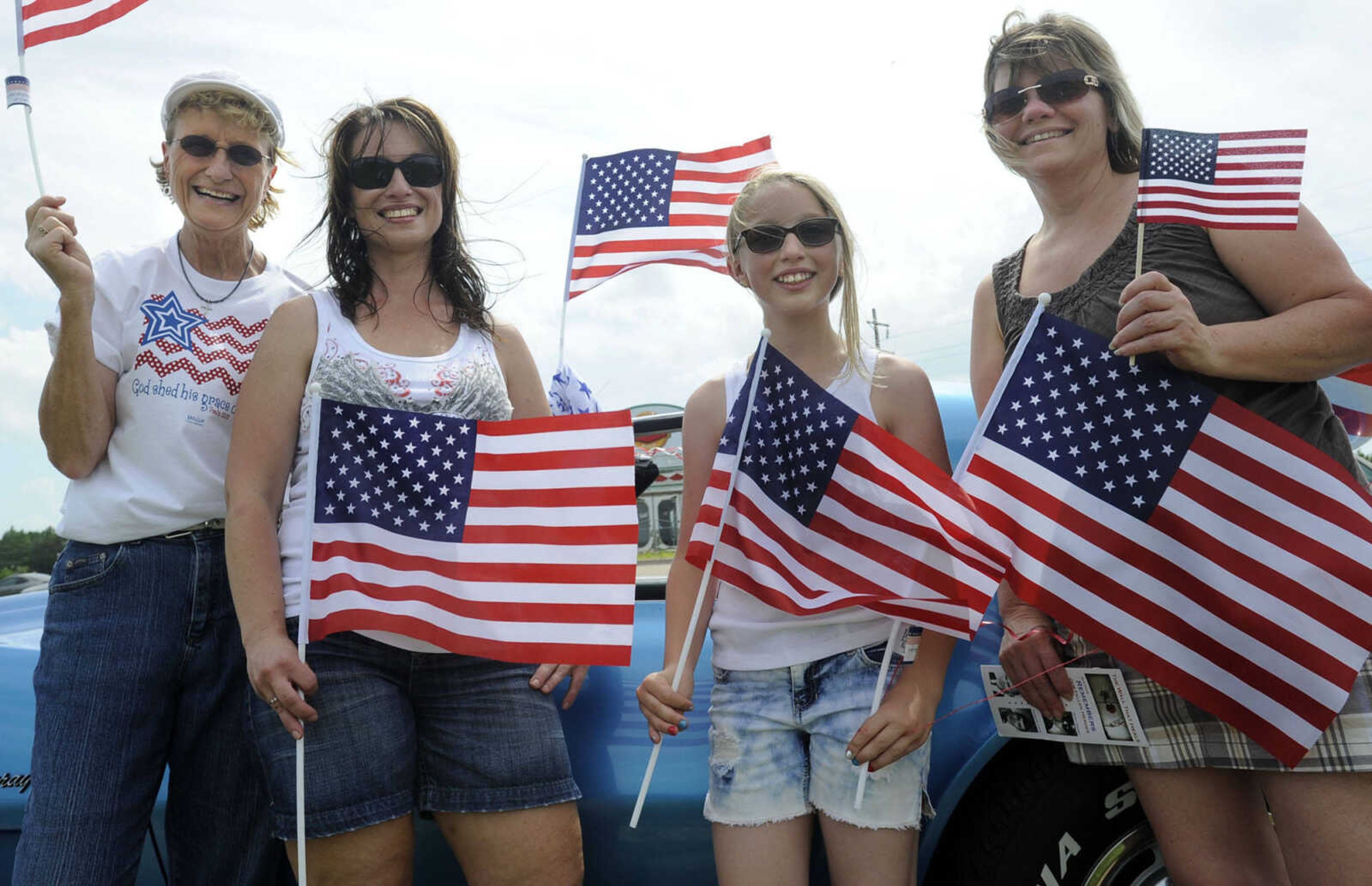 Judi Lawrence, left, Chantel Lawrence, Allison Bahr and Grace Miesner  pose for a photo Tuesday, June 17, 2014 at the arrival of the Vietnam Veterans Memorial replica in Perryville, Mo.