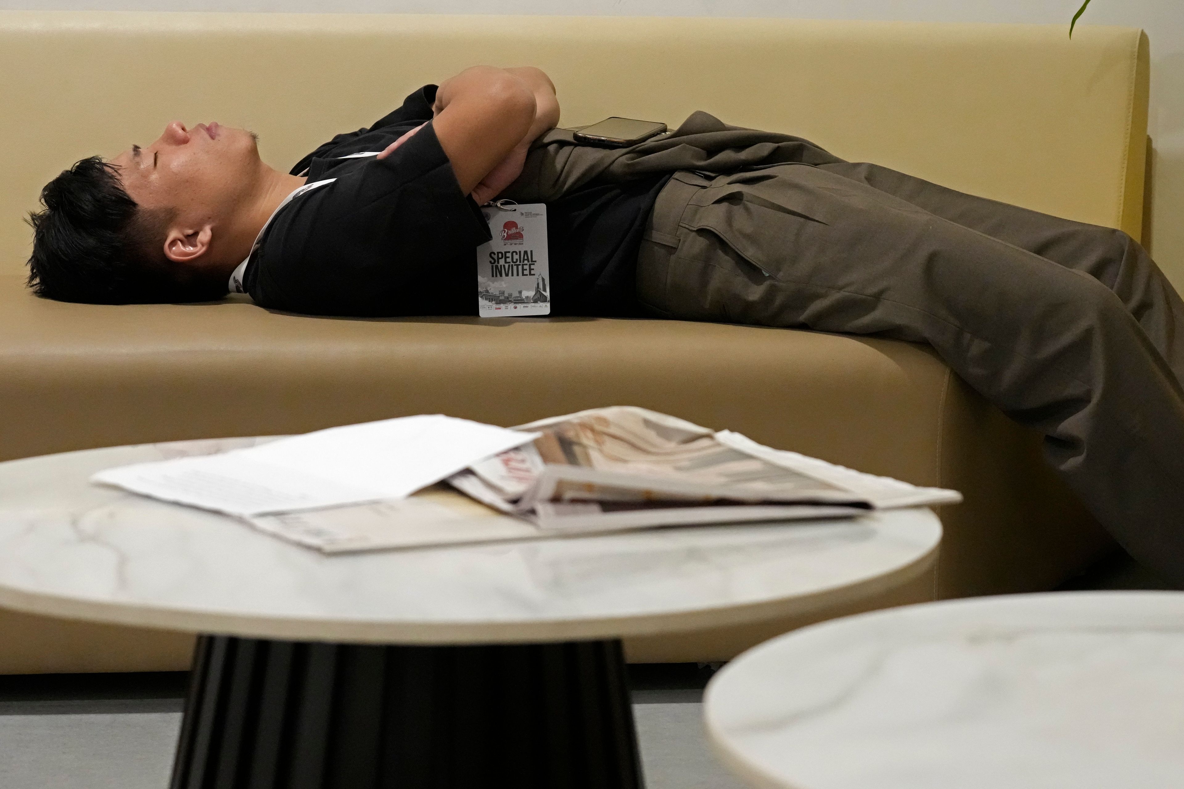 Takosangba Jamir, 27, a blind pianist, rests on a sofa in the green room before his performance at the two-day Brillante Piano Festival in Bengaluru, India, Sunday, Sept. 29, 2024. (AP Photo/Aijaz Rahi)