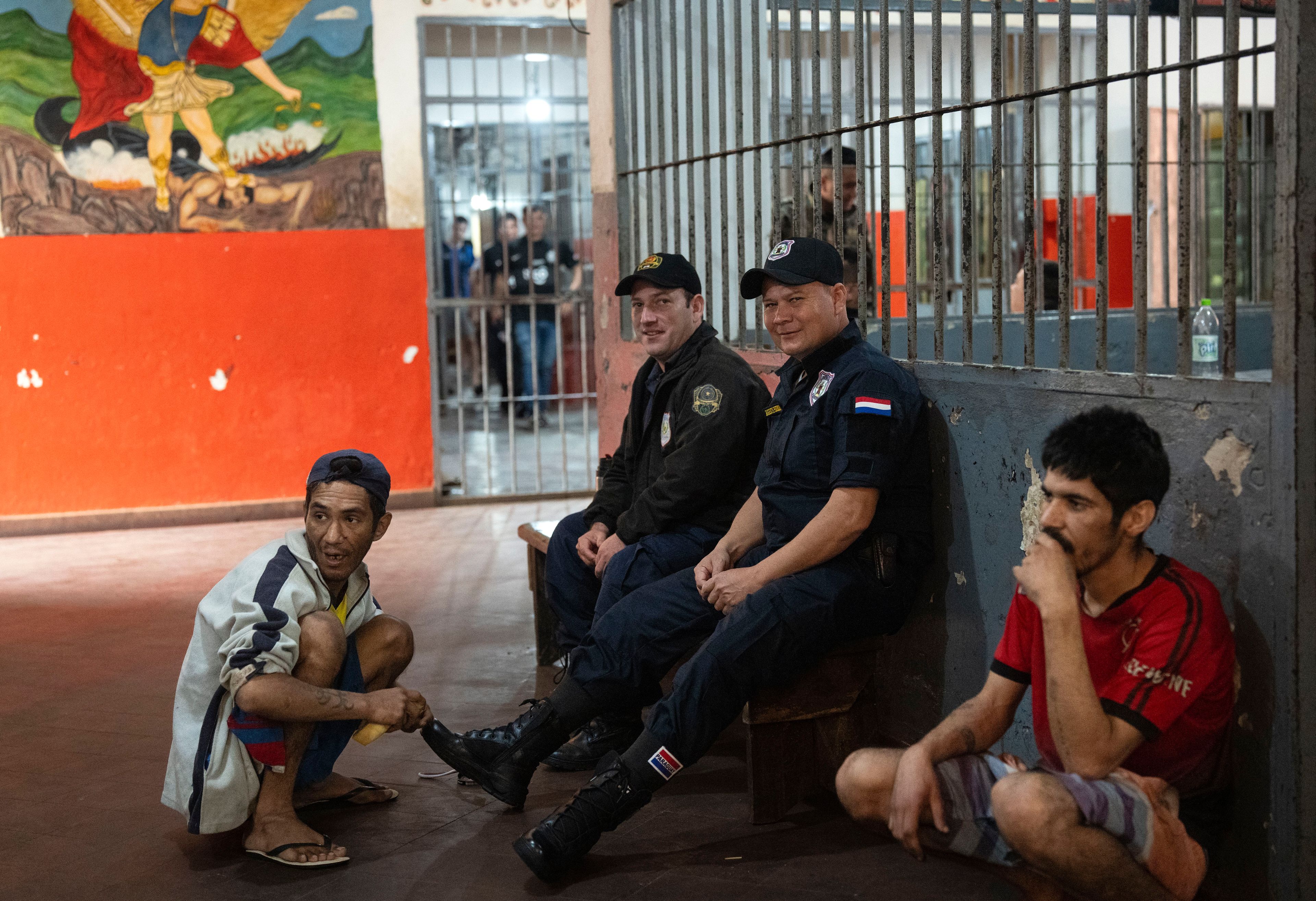 Prisoner Antolin Rojas, 32, shines the shoes of a prison guard, for 2000 Guaranies, or about 30 cents, at the Regional Penitentiary in Coronel Oviedo, Paraguay, Saturday, Aug. 31, 2024. (AP Photo/Rodrigo Abd)