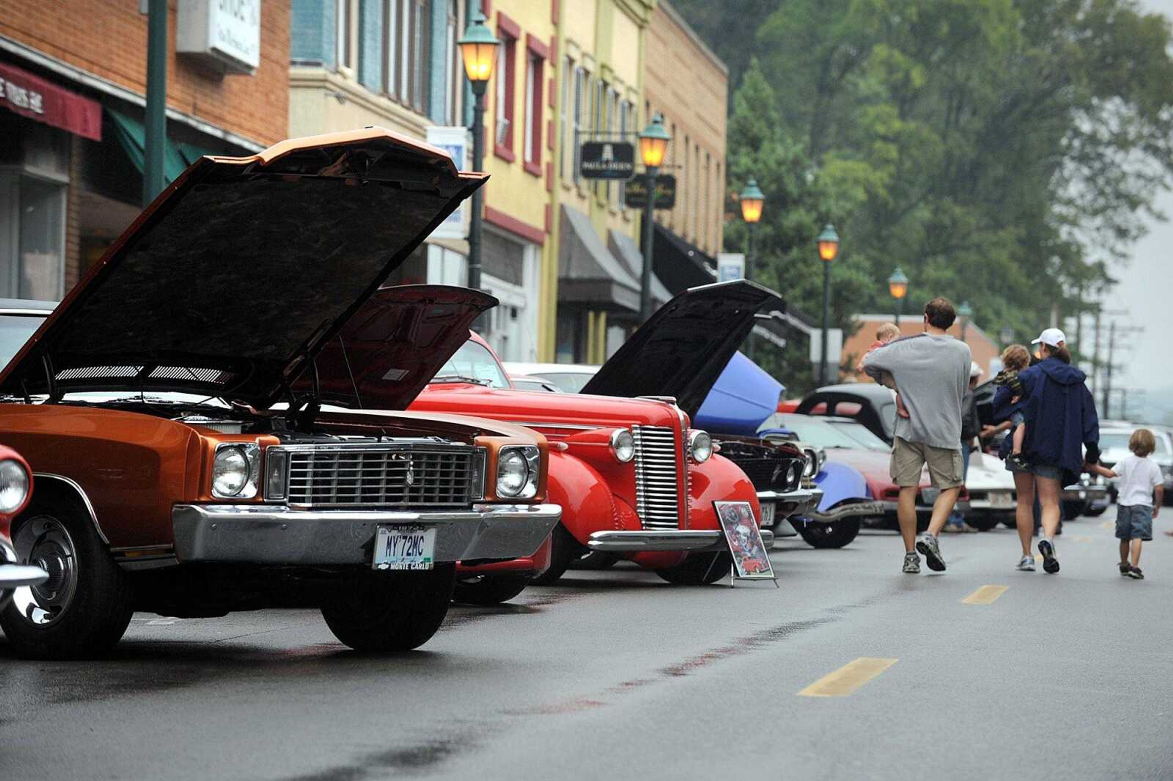 People peruse the classic cars parked along Main Street Sunday, Sept. 16, 2012 during the River Tales Classic Car Show sponsored by the River City Rodders in downtown Cape Girardeau. (Laura Simon)