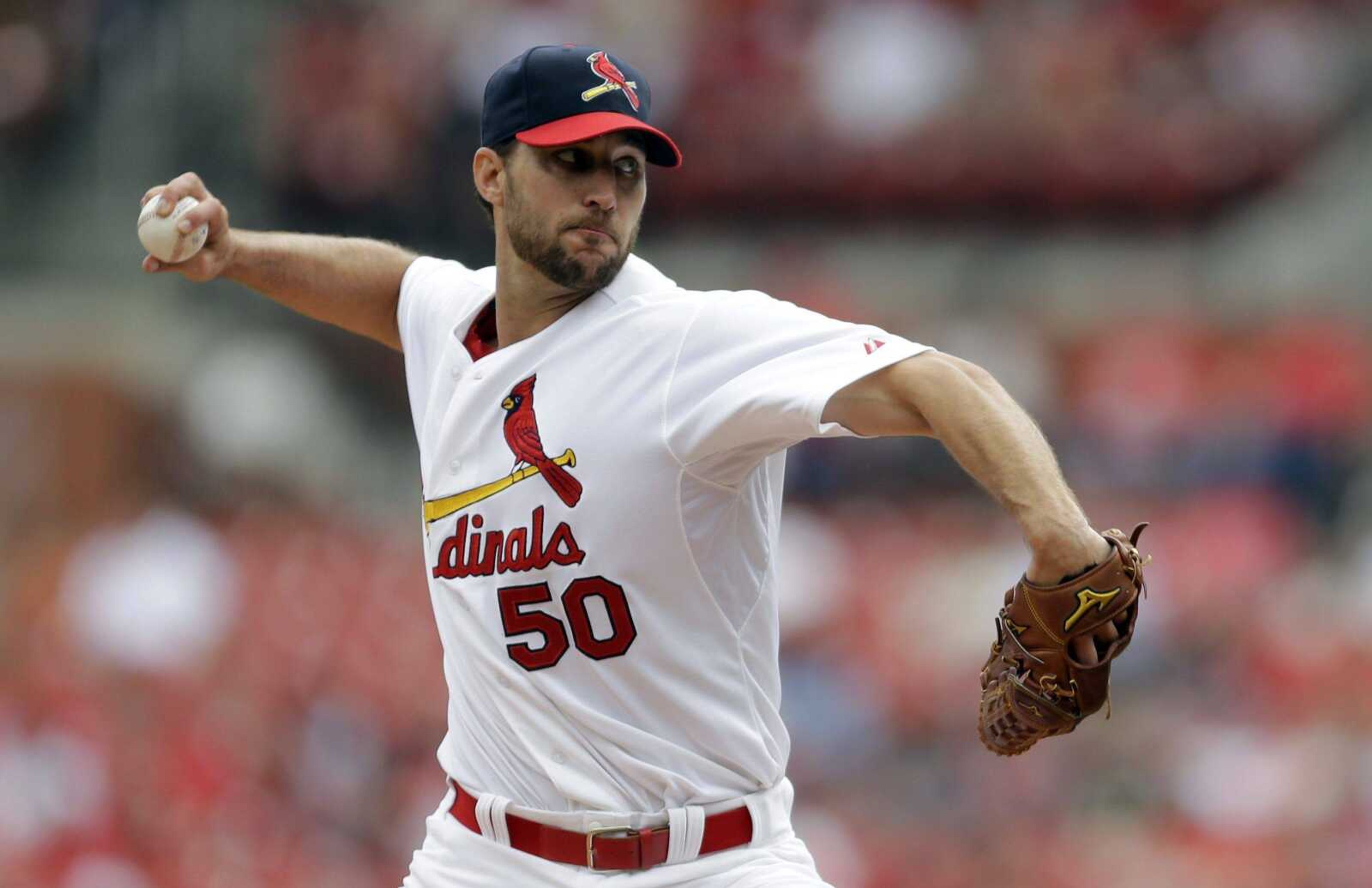 Cardinals starting pitcher Adam Wainwright throws to a Pirates batter during the first inning Sunday in St. Louis. (Jeff Roberson ~ Associated Press)