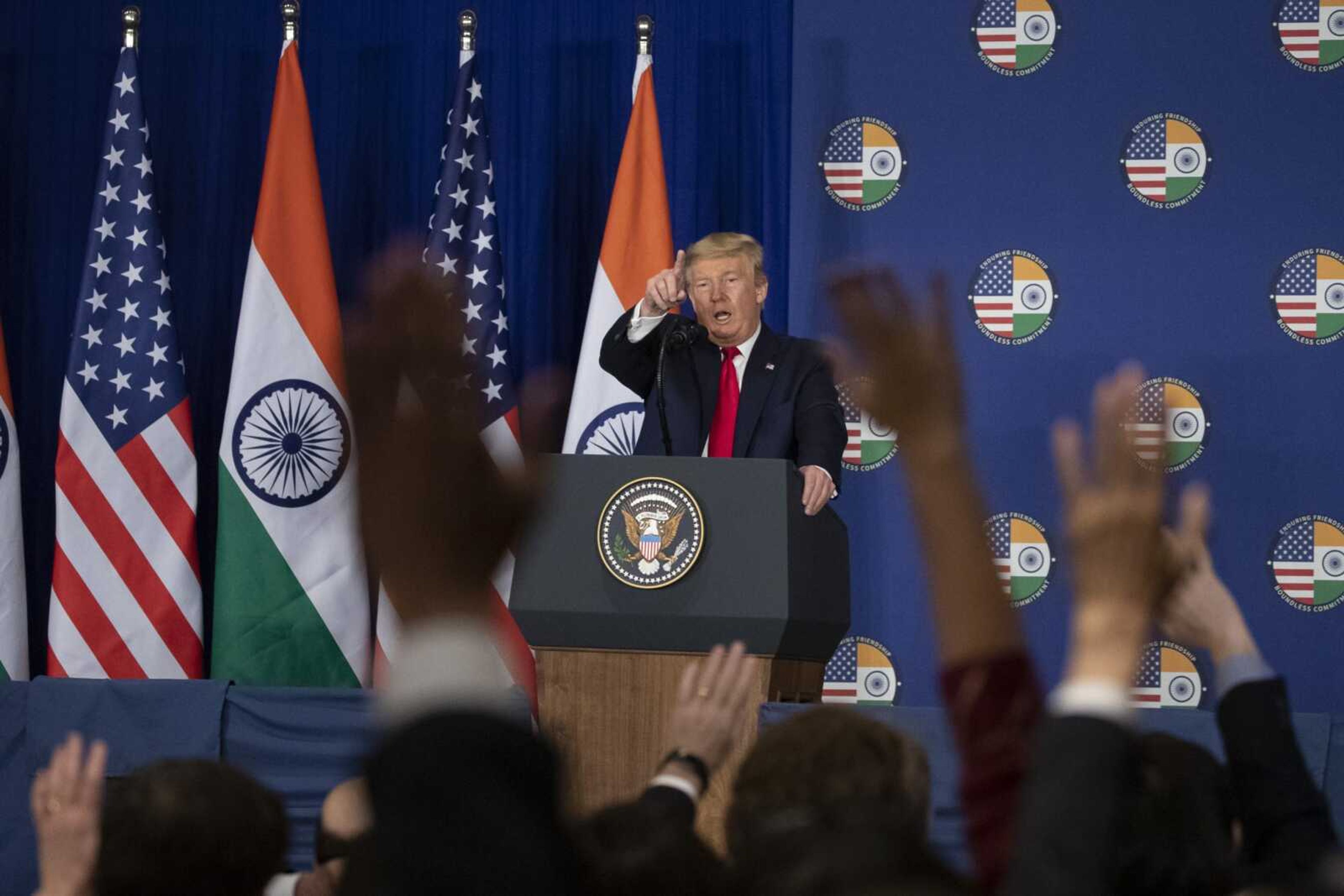 President Donald Trump points to a questioner during a news conference Tuesday in New Delhi.