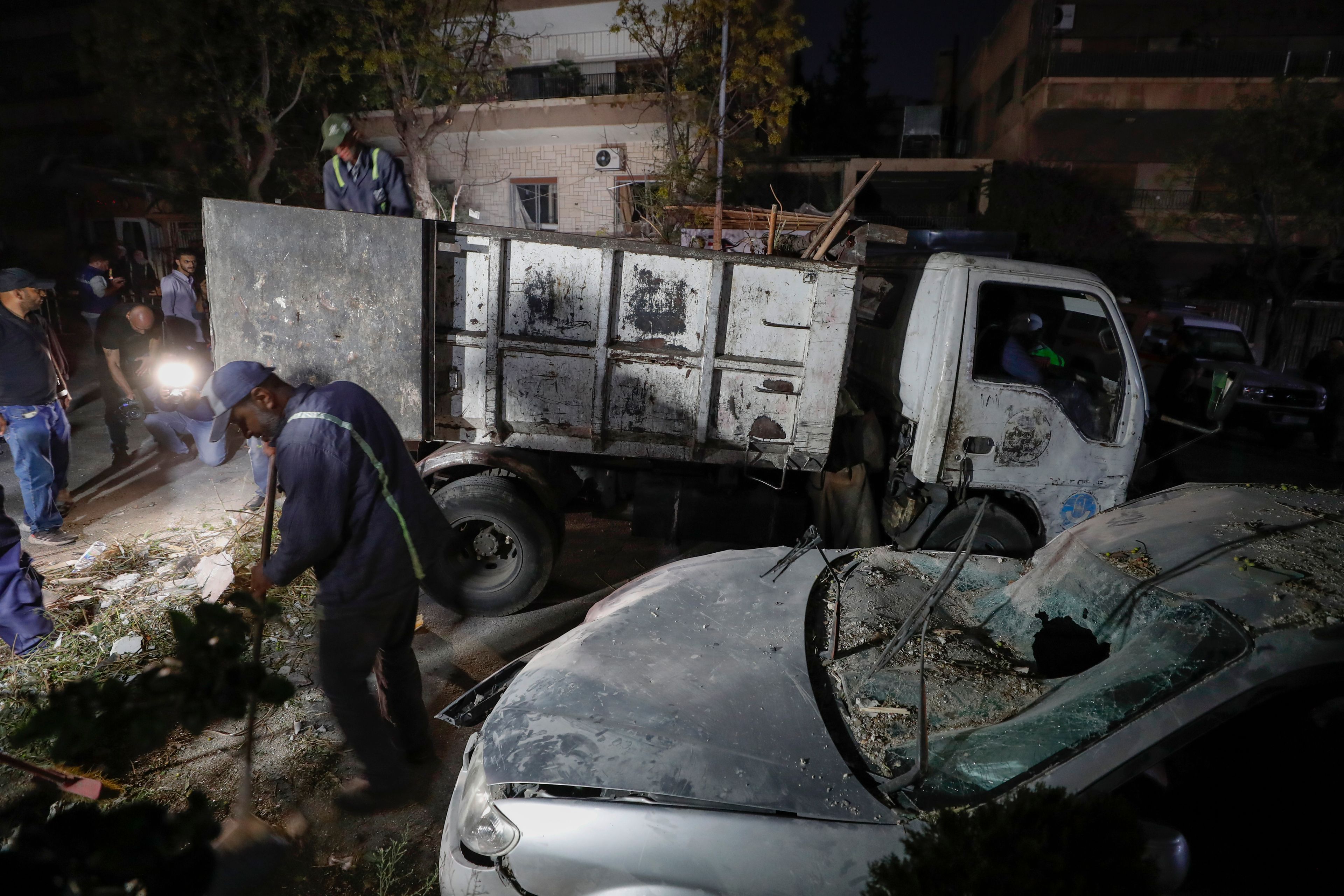 Workers clean at the site of an apparent Israeli airstrike in Damascus, Syria, Wednesday, Oct. 2, 2024. (AP Photo/Omar Sanadiki)