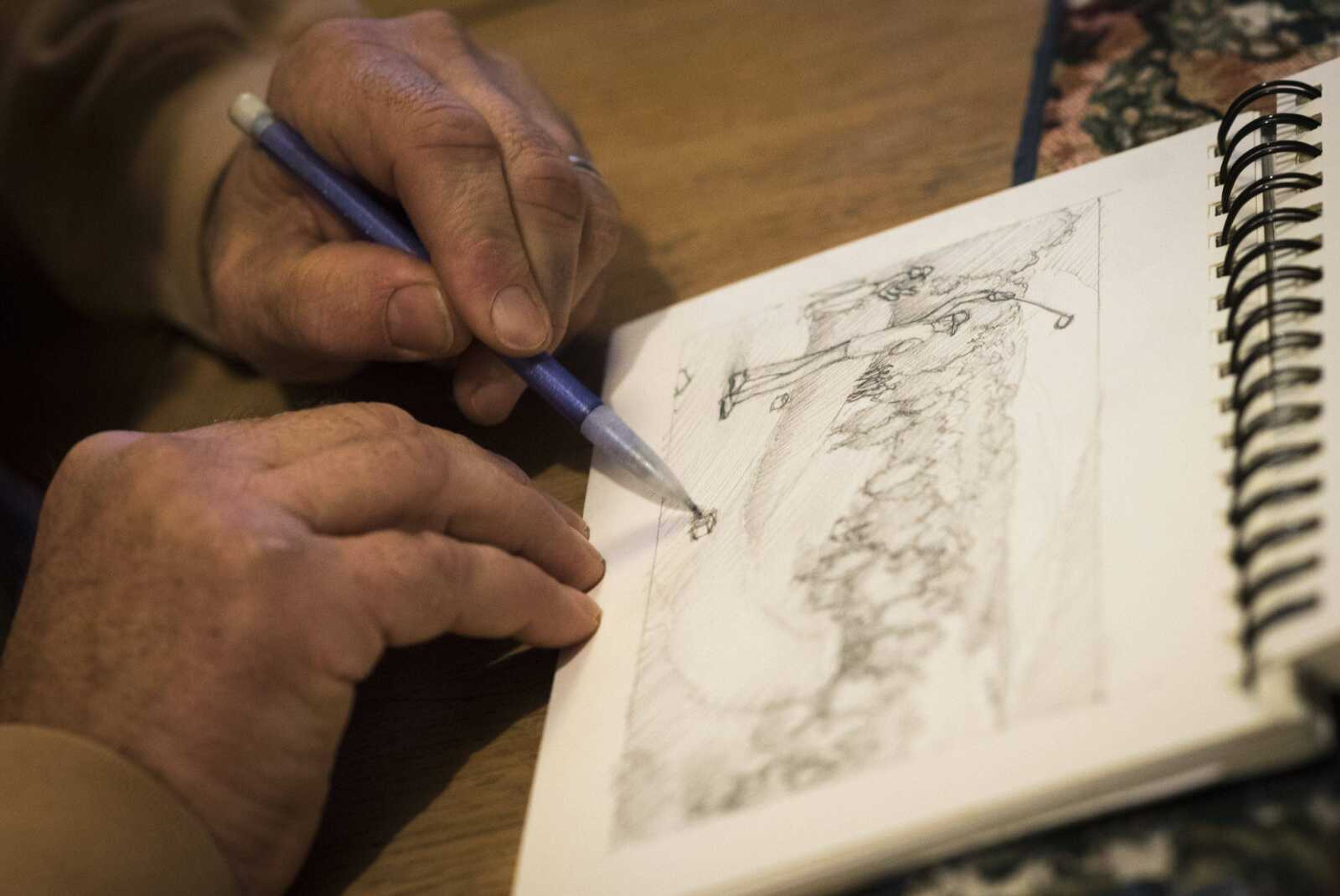 Cape Girardeau artist Craig Thomas sketches thumbnail drafts while working on a project Dec. 19 at his home in Cape Girardeau.