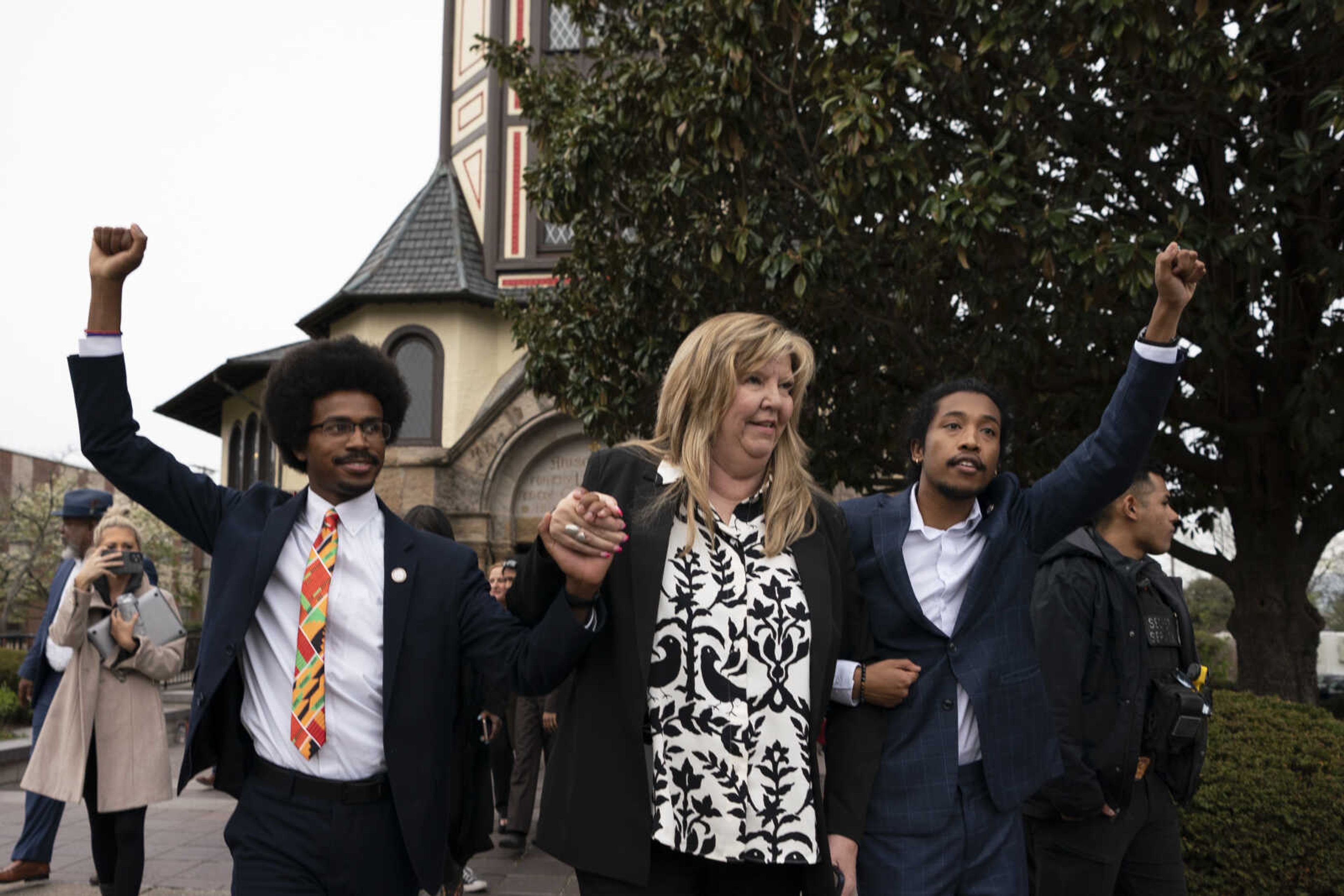 From left, expelled Rep. Justin Pearson, D-Memphis, Rep. Gloria Johnson, D-Knoxville, and expelled Rep. Justin Jones, D-Nashville, raise their fists as they walk across Fisk University campus after hearing Vice President Kamala Harris speak Friday in Nashville, Tennessee.