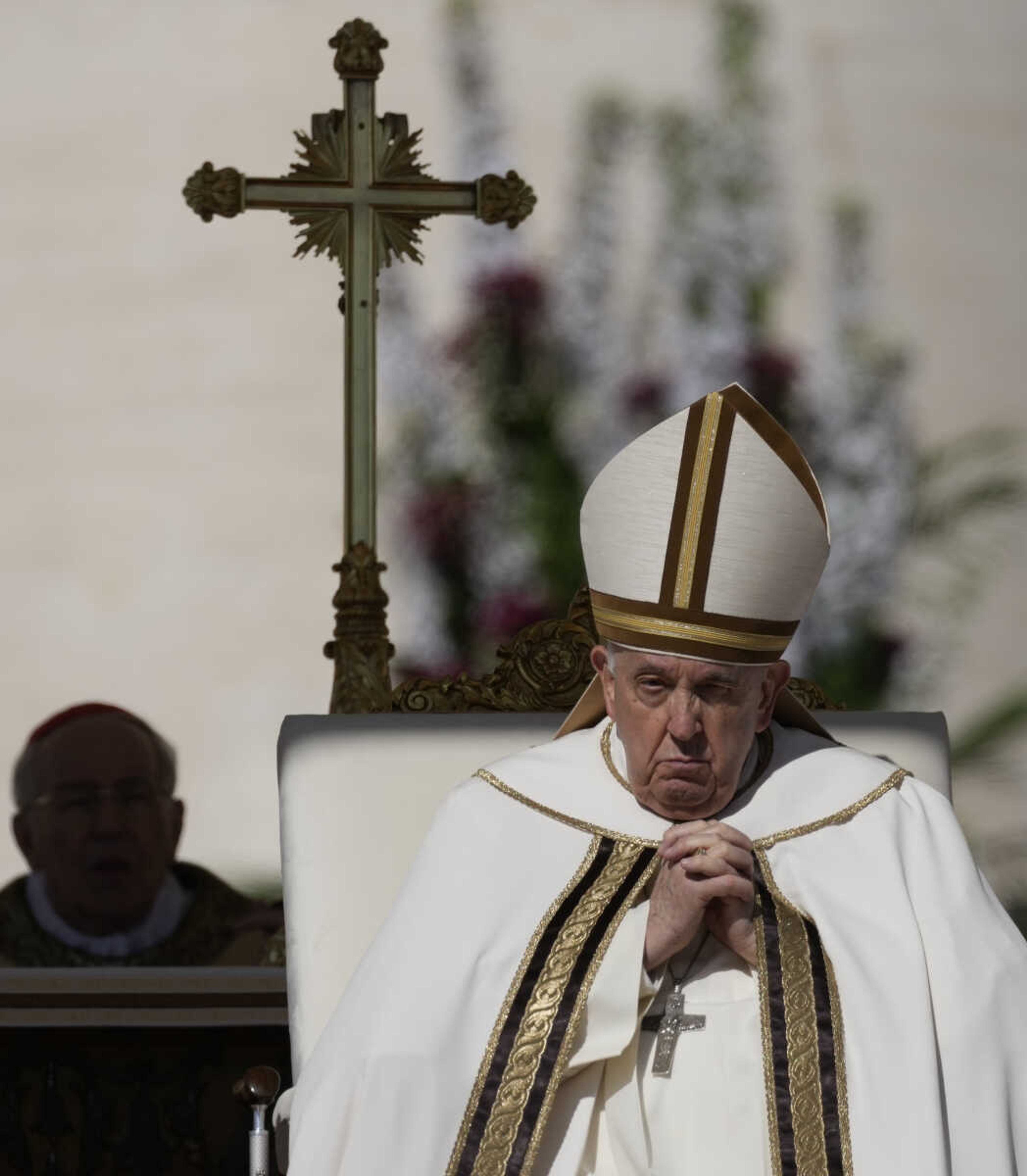 Pope Francis sits on the altar Sunday in St. Peter's Square at The Vatican during the Easter Sunday Mass.