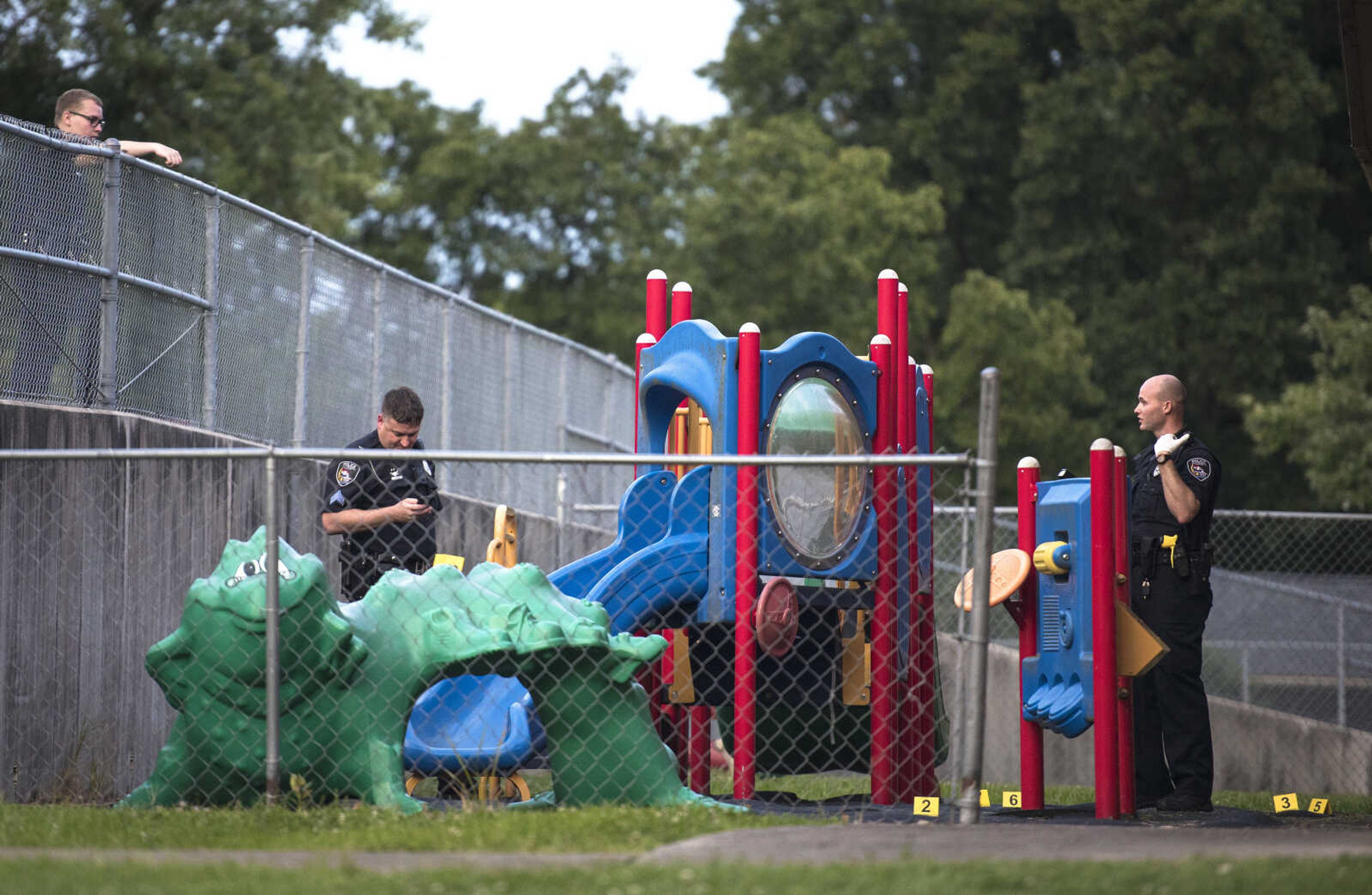 Members of the Cape Girardeau Police Department mark evidence at the scene of a shooting Monday, July 29, 2019, outside of Jefferson Elementary in Cape Girardeau.