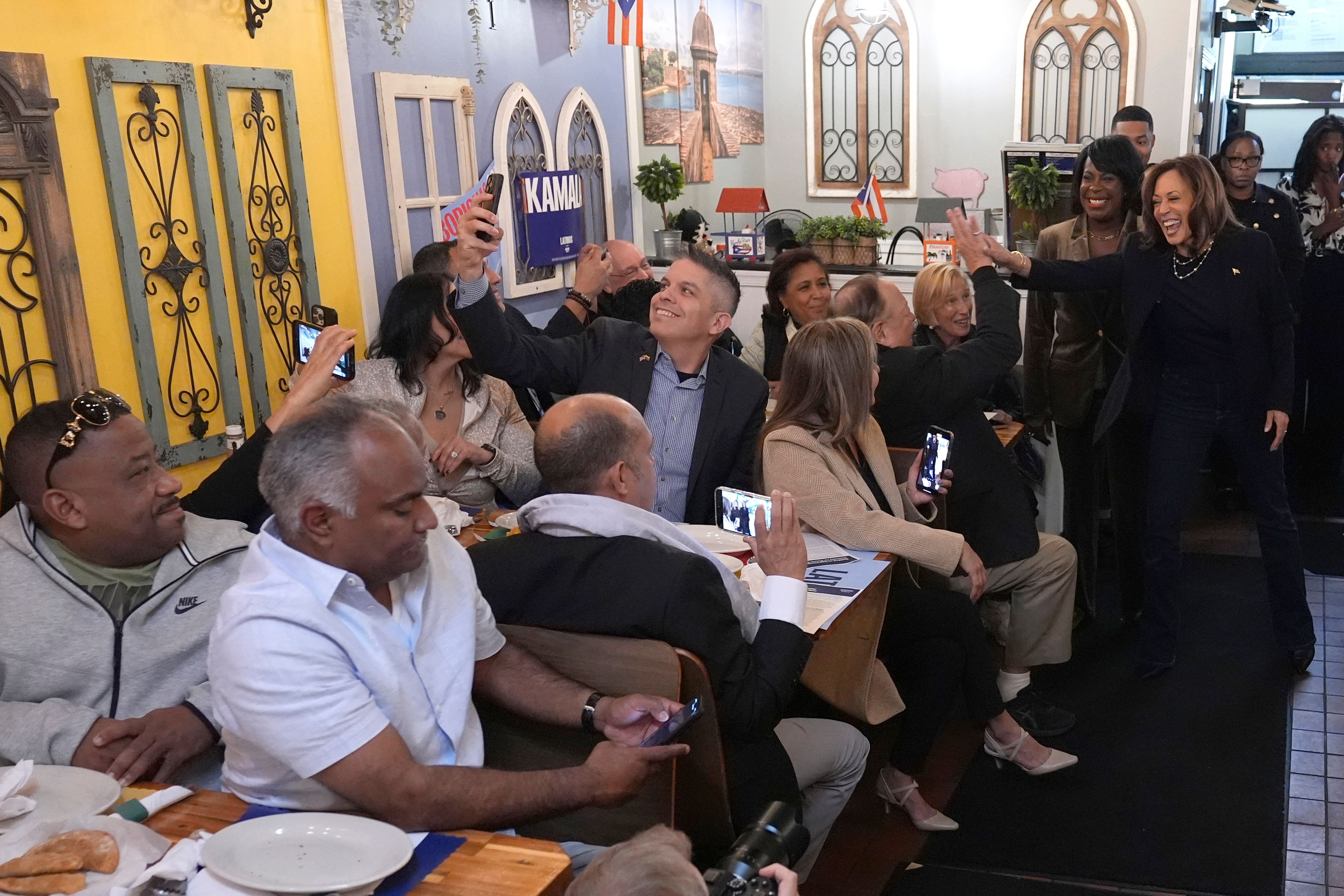 Democratic presidential nominee Vice President Kamala Harris, from right, arrives with Philadelphia Mayor Cherelle Parker to Freddy and Tony's restaurant during a campaign stop, Sunday, Oct. 27, 2024, in Philadelphia. (AP Photo/Susan Walsh)