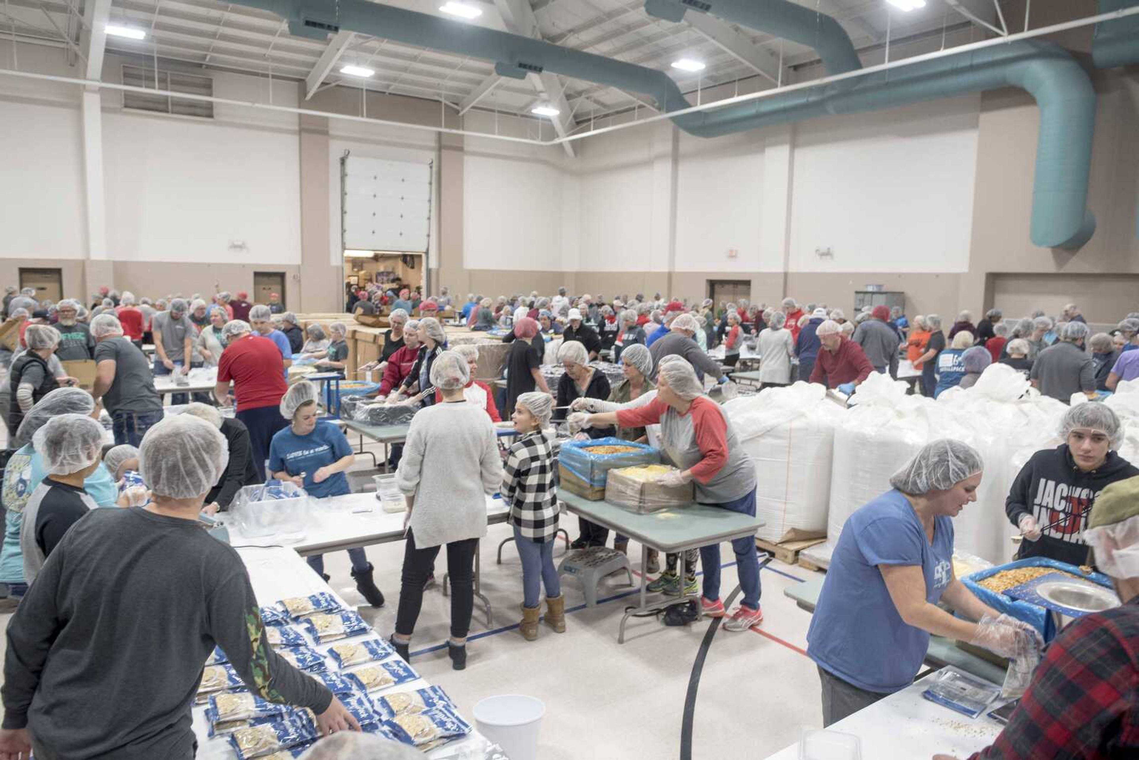 Volunteers work to prepare meals during a Feed My Starving Children meal packing event hosted by La Croix Church Friday, Dec. 6, 2019, at the Osage Centre in Cape Girardeau.