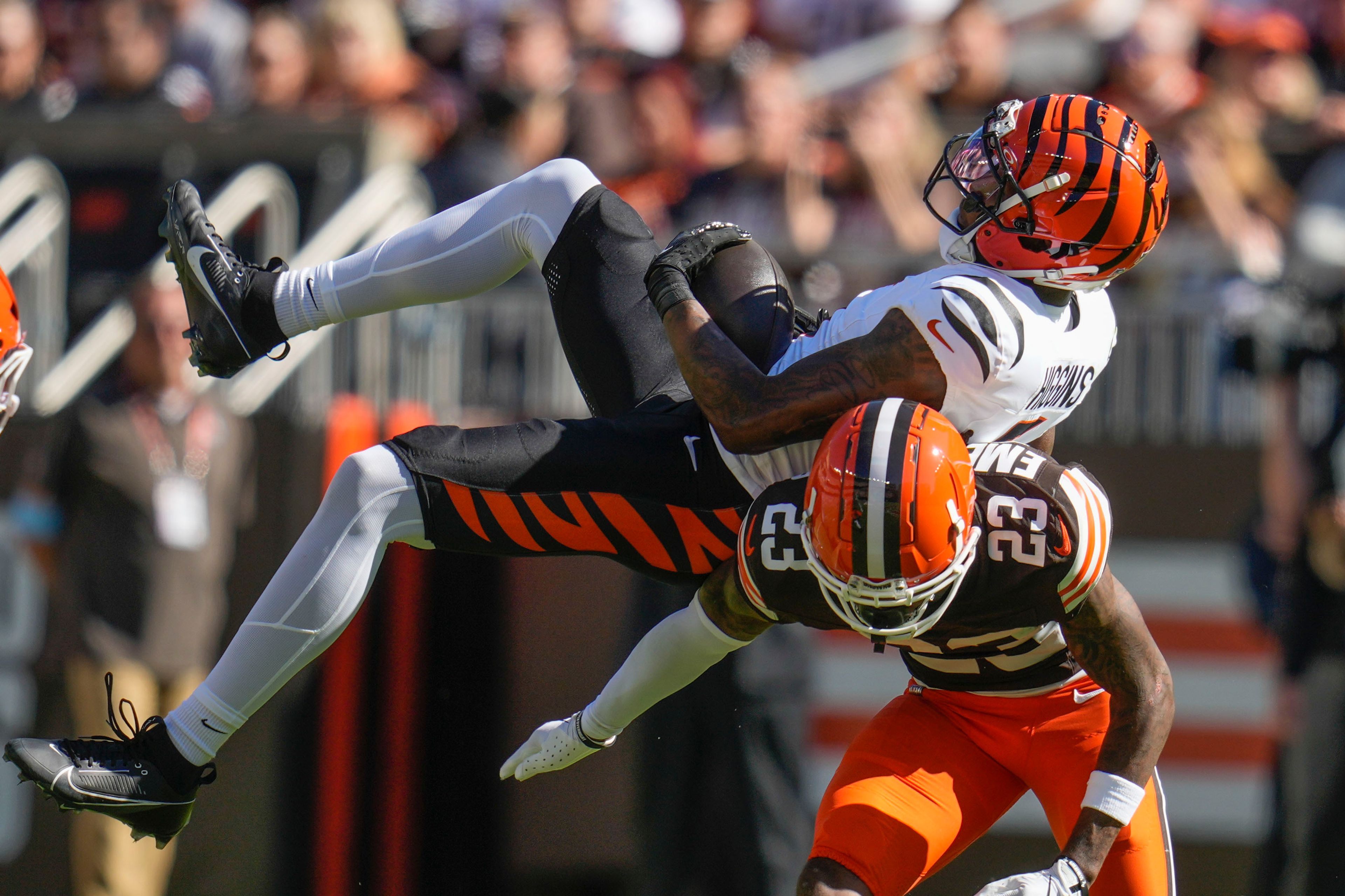 Cincinnati Bengals wide receiver Tee Higgins (5) pulls in a pass reception over Cleveland Browns cornerback Martin Emerson Jr. (23) in the first half of an NFL football game, Sunday, Oct. 20, 2024, in Cleveland. (AP Photo/Sue Ogrocki)