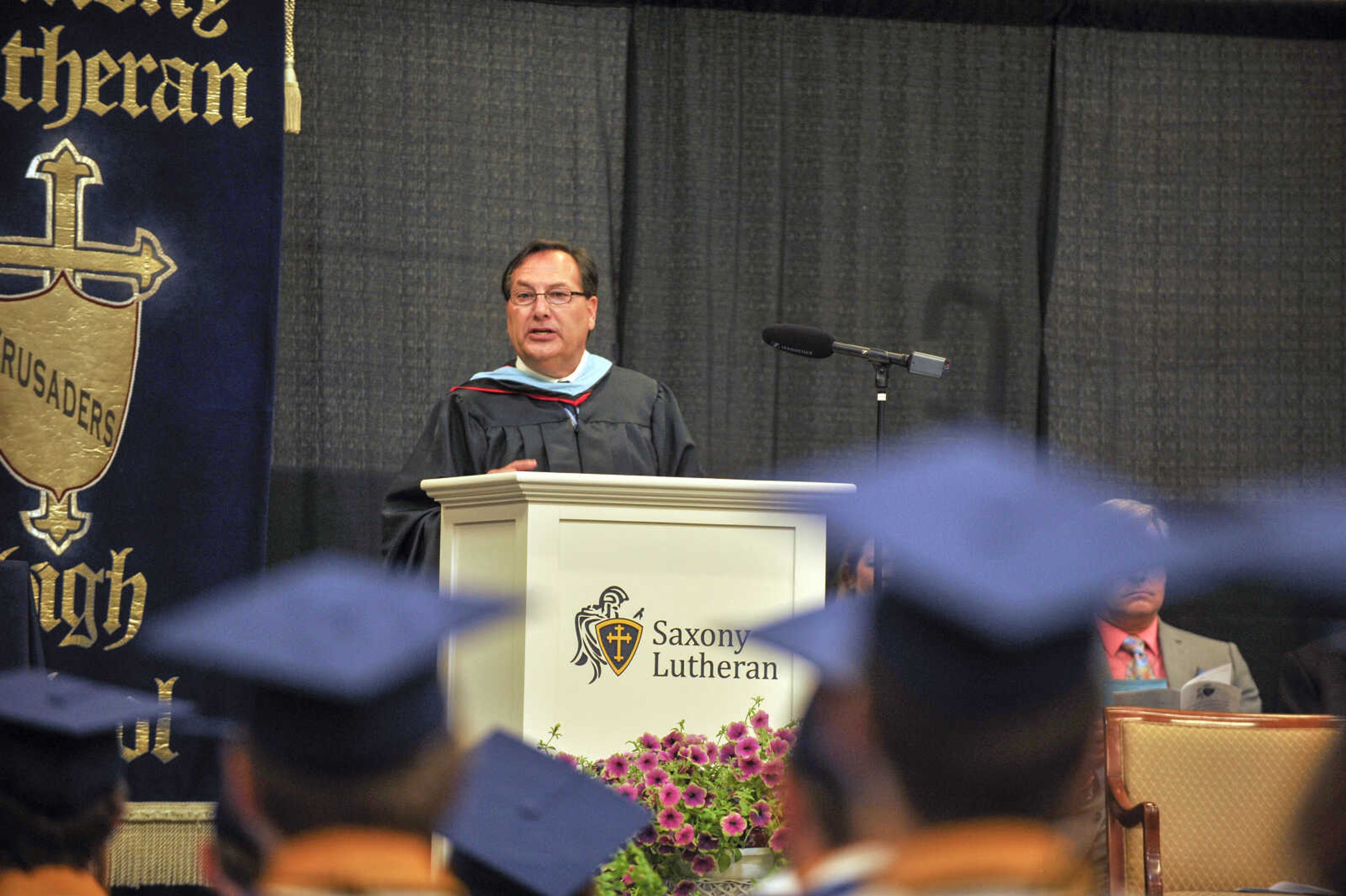 Saxony Lutheran High School principal Mark Ruark welcomes seniors to graduation on Sunday, May 16, 2021. "This class has shown perseverance unlike any I have seen," Ruark said.