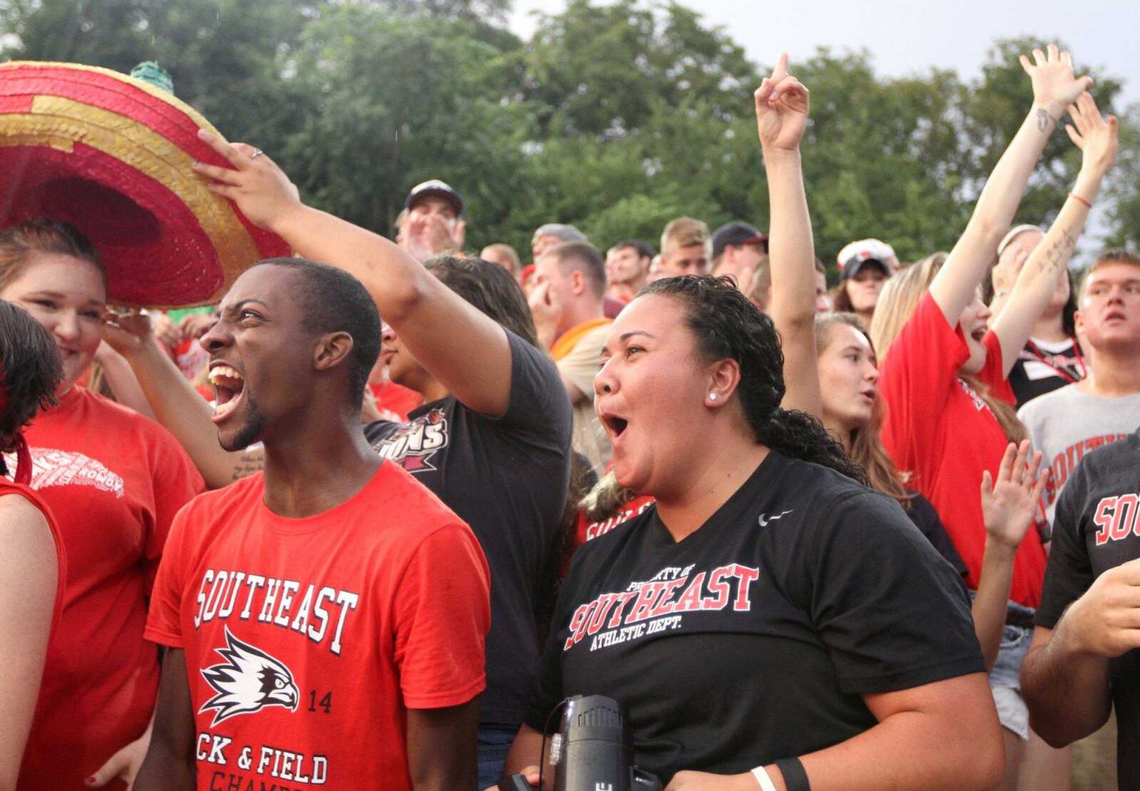 Southeast Missouri State University students Kameron Long and Courtney Gapelu celebrate after a big play during the first football game of the season against Missouri Baptist at Houck Stadium in Cape Girardeau Thursday, Aug. 28, 2014. (Glenn Landberg)