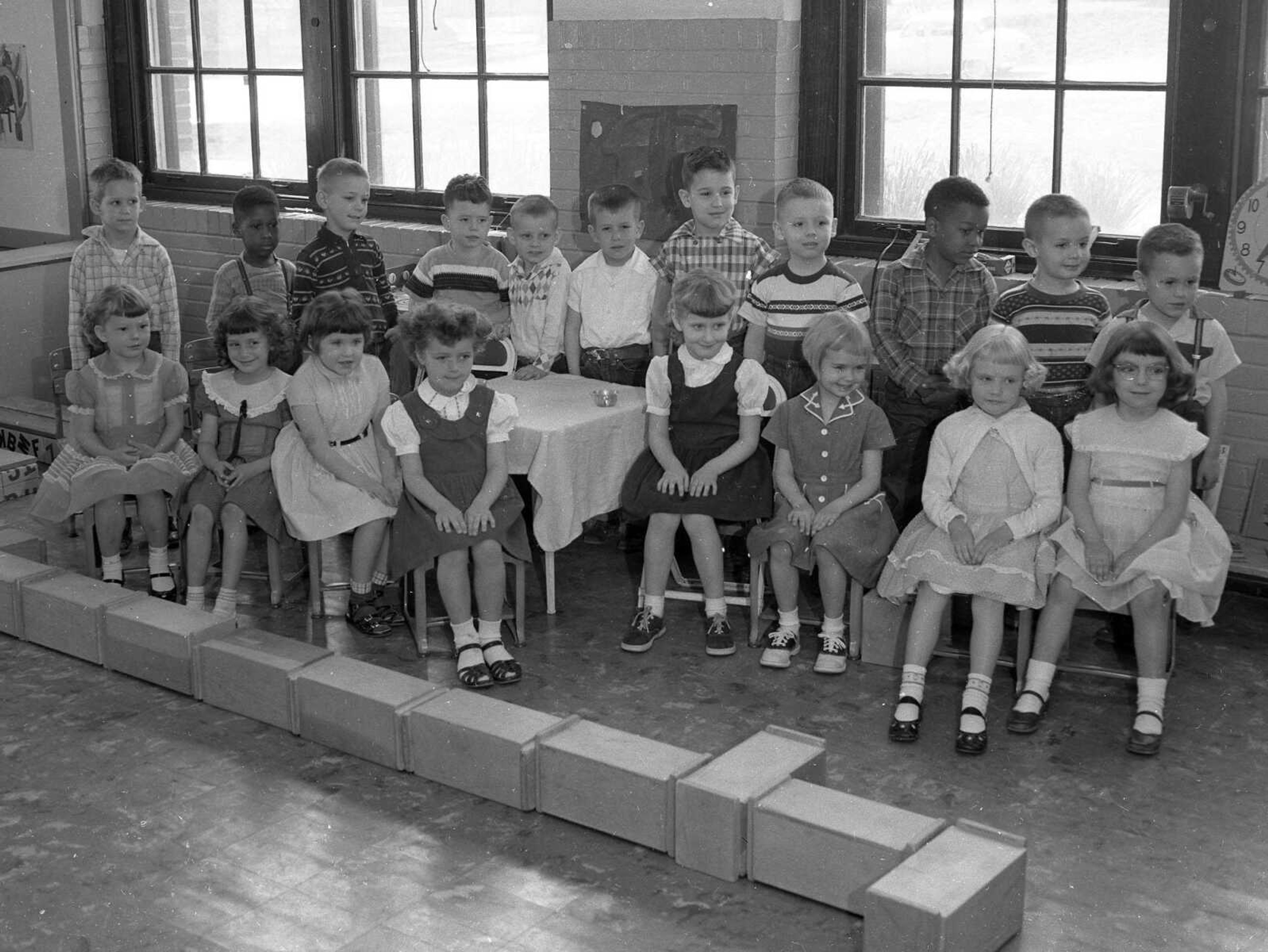 April 14, 1956 Southeast Missourian.
This morning kindergarten class at Washington School, taught by Mrs. Dan Miller, showed every enjoyment of their session as they took time out from play, and learning to pose for a picture. From the left, standing: Steven Ates, Eugene Wilson, Hollis Headrick, Kenneth LaMar, Richard Margrabe, Monty Heise, Michael Taylor, Jerry Adkins, Robert Estes, James Earl Markert and Richard Tice. Seated: Beverly Northdurft, Helen Kurtz, Candace Maxey, Brenda Koeppel, Donna Kay Sample, Ann Erlbacher, Judith Break and Sharon Hunt. (G.D. Fronabarger photo)