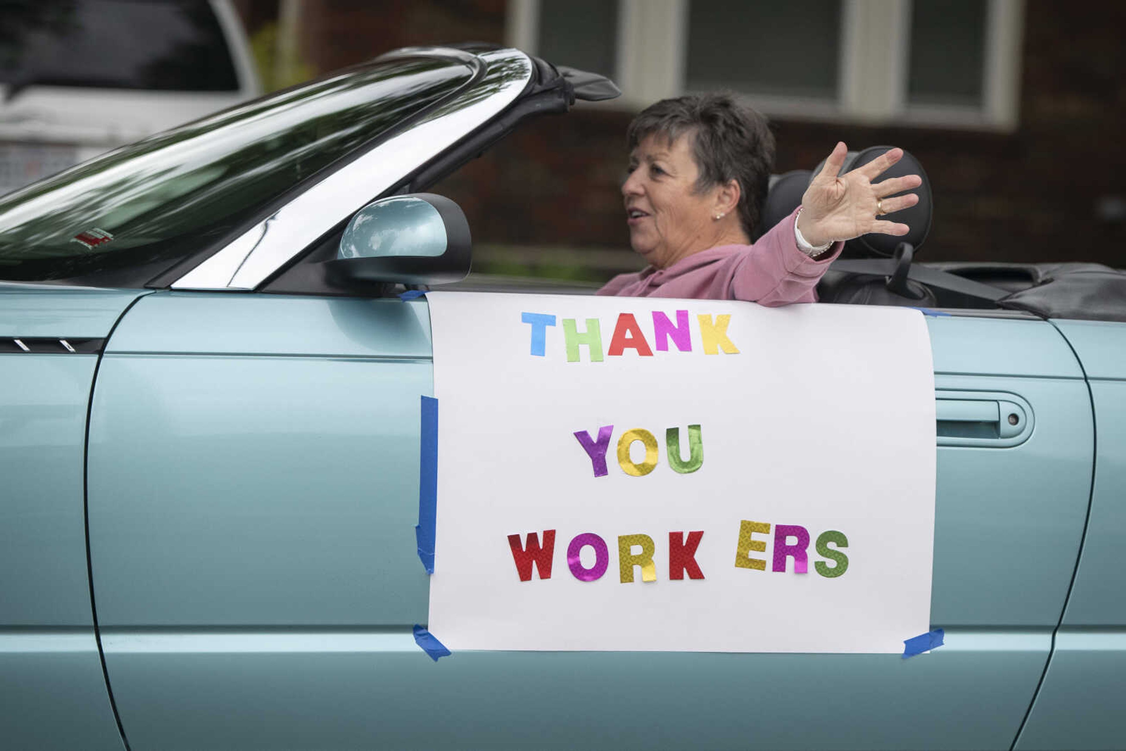 Ruth Ellen Holdman of Cape Girardeau, with the River City Rodders, waves while driving past Franklin Elementary School during the United Way of Southeast Missouri's #GiveUnitedCarParade on Tuesday, May 5, 2020, in Cape Girardeau.