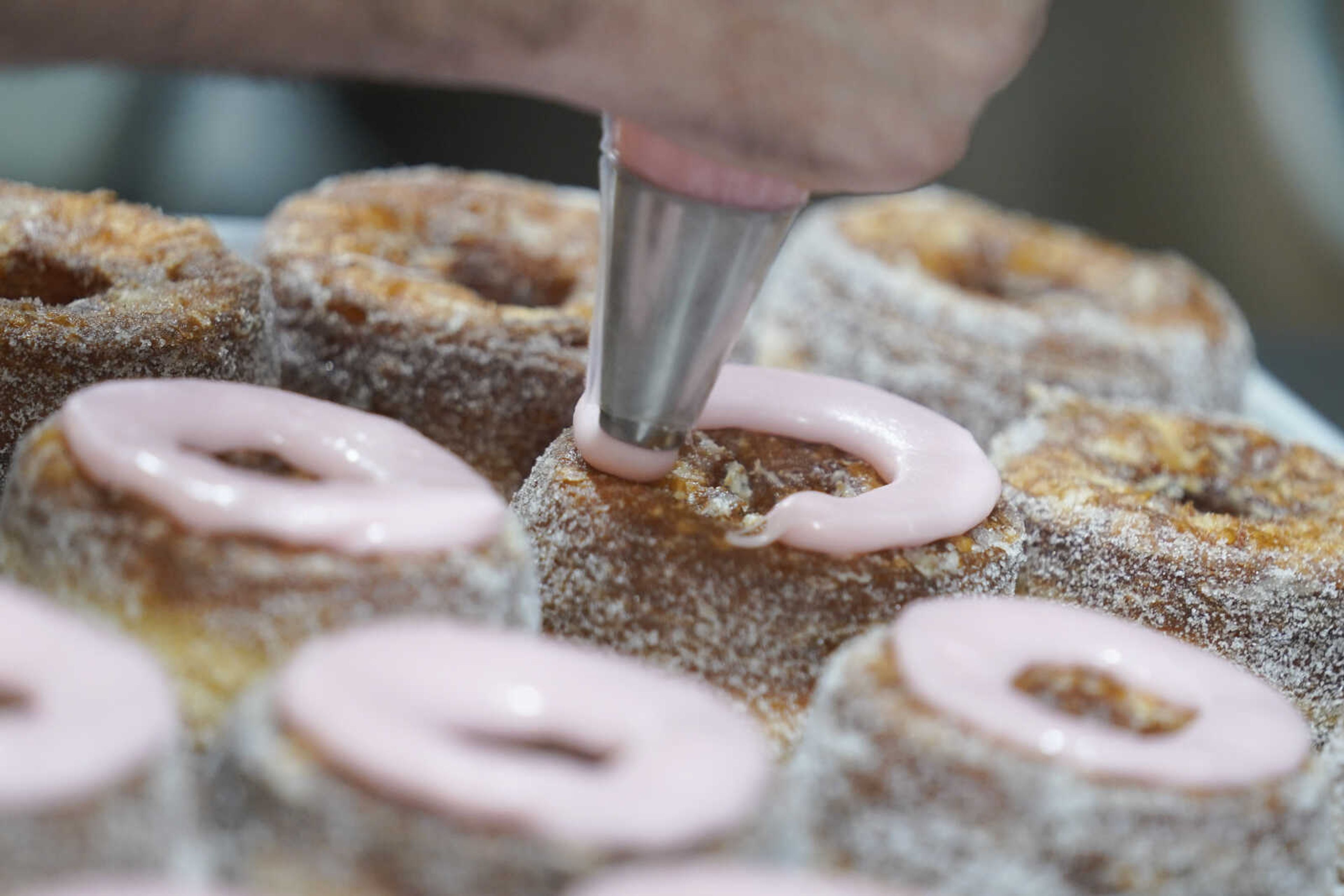 Dominique Ansel ices Cronuts before the opening of his namesake bakery Sept. 28 in New York.