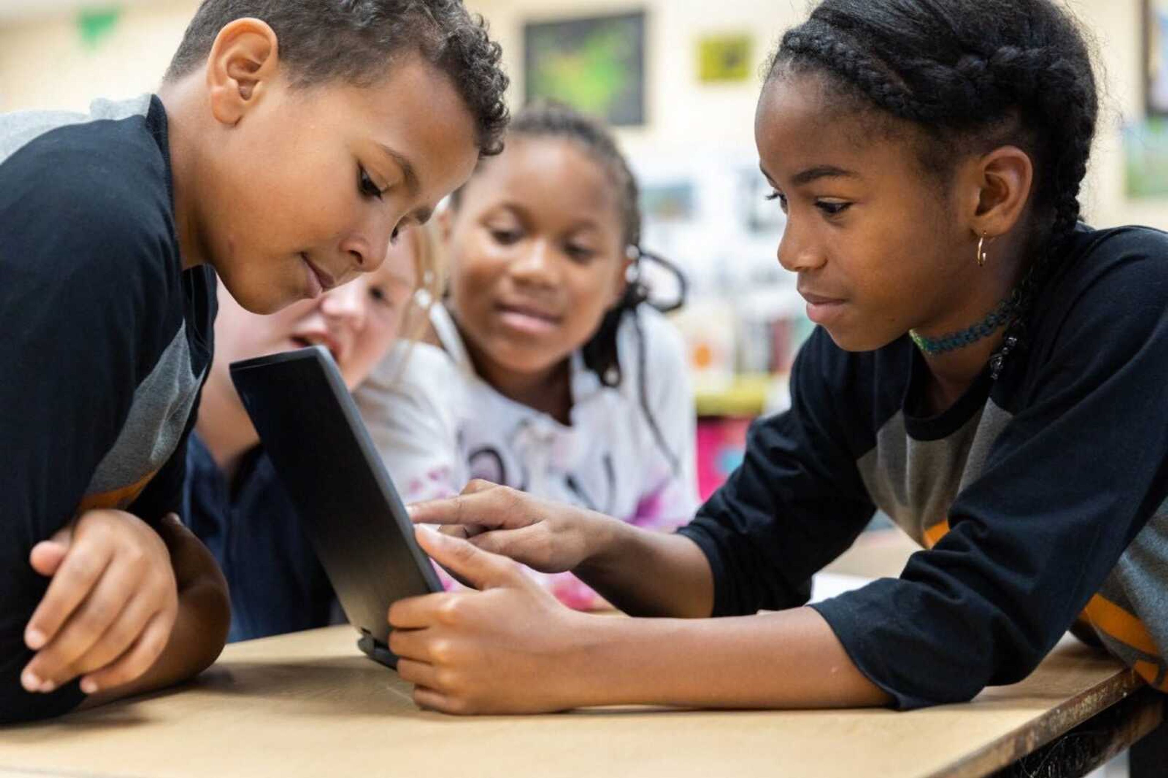 Youth Coding League players assemble code on laptops Sept. 25.