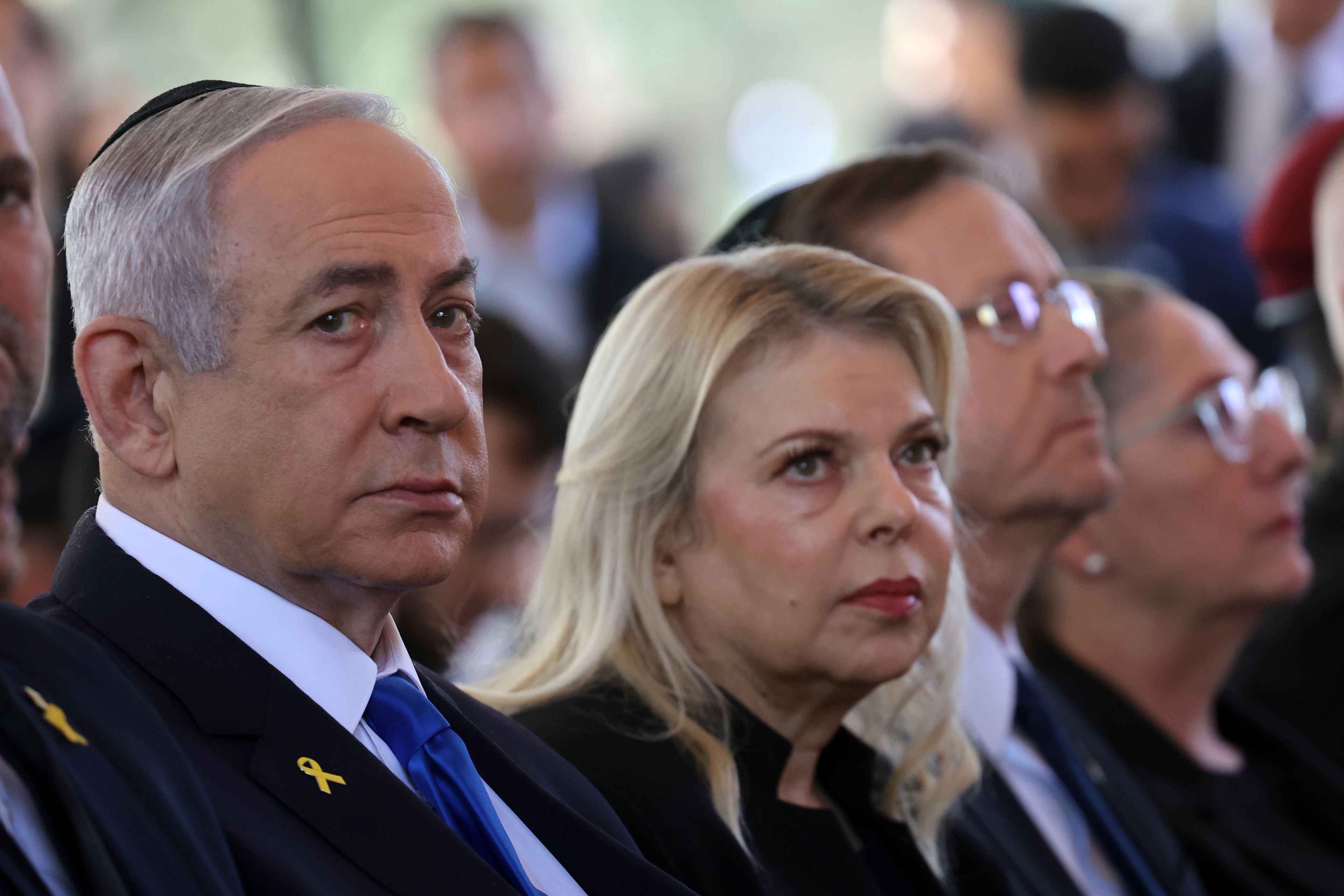 Israel's Prime Minister Benjamin Netanyahu, from left, his wife Sara Netanyahu, President Isaac Herzog and First Lady Michal Herzog, attend a ceremony marking the Hebrew calendar anniversary of the Hamas attack on October 7 last year that sparked the ongoing war in Gaza, at the Mount Herzl military cemetery in Jerusalem, Israel Sunday Oct. 27, 2024. (Gil Cohen-Magen/Pool Photo via AP)