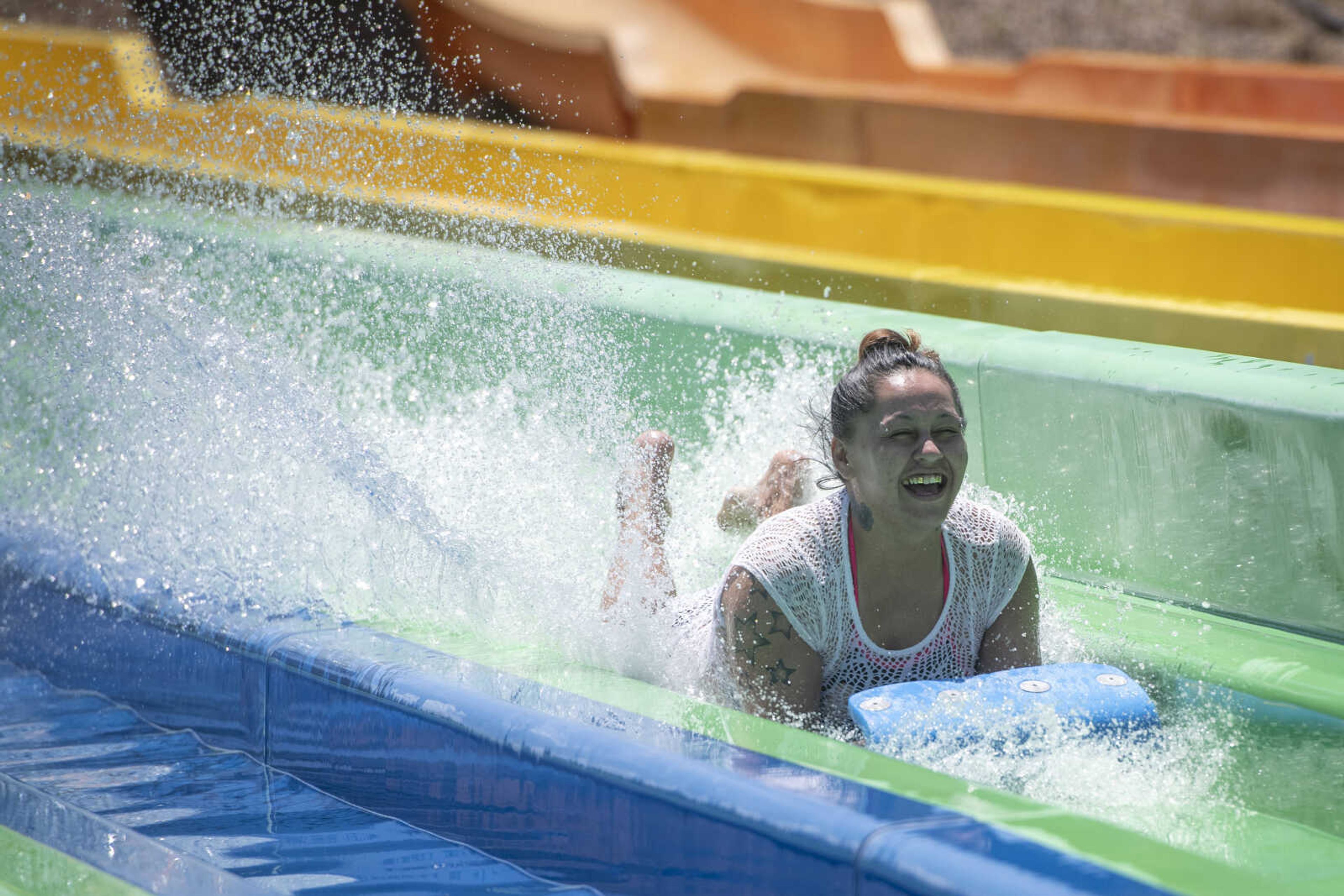 Dava Poyner of Sikeston, Missouri, goes down a water slide Wednesday, June 10, 2020, at Cape Splash Family Aquatic Center in Cape Girardeau.