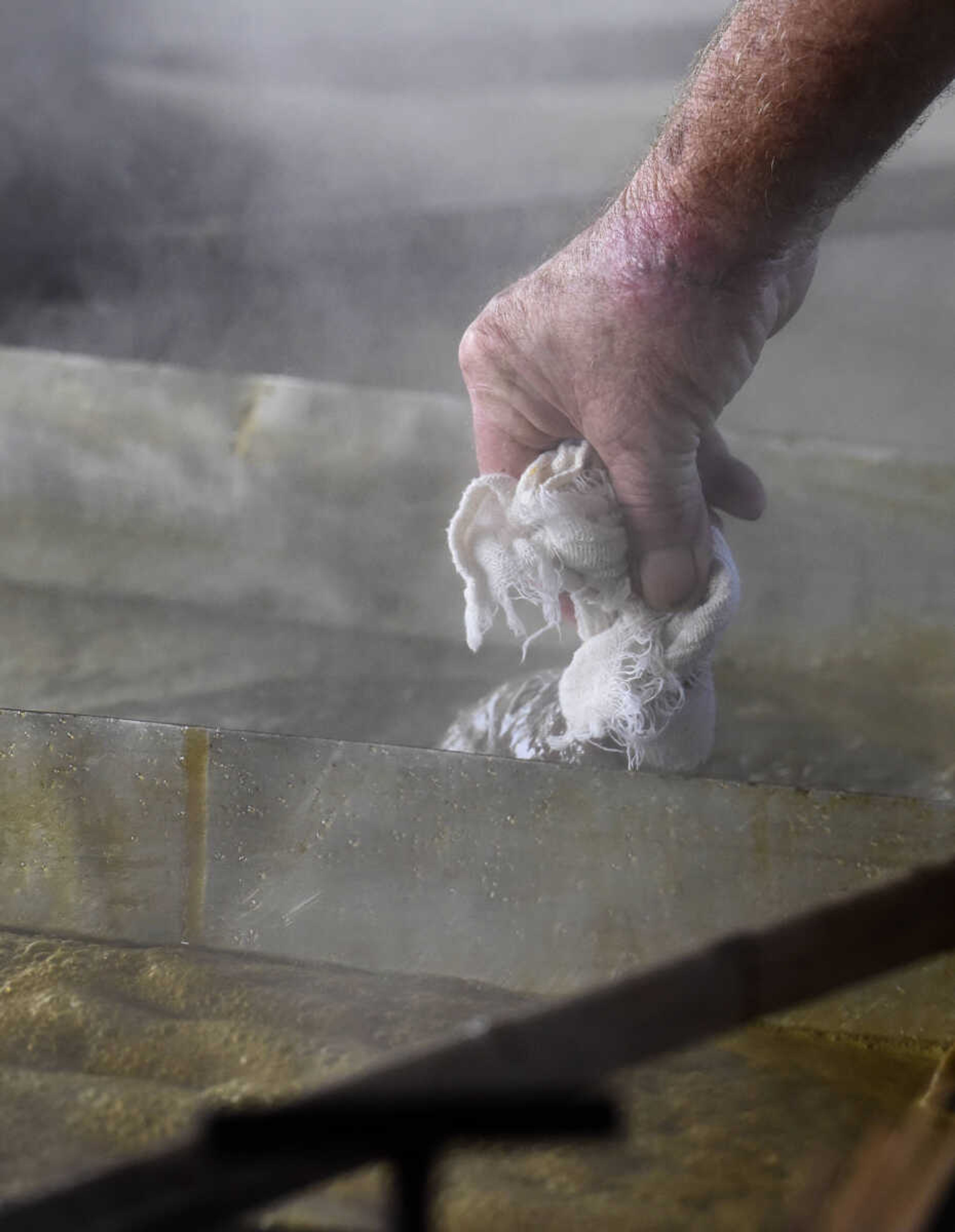 LAURA SIMON ~ lsimon@semissourian.com

Ralph Enderle places a cheese cloth on the cooking pan that helps strain the sorghum on Monday, Oct. 10, 2016, in New Hamburg, Missouri