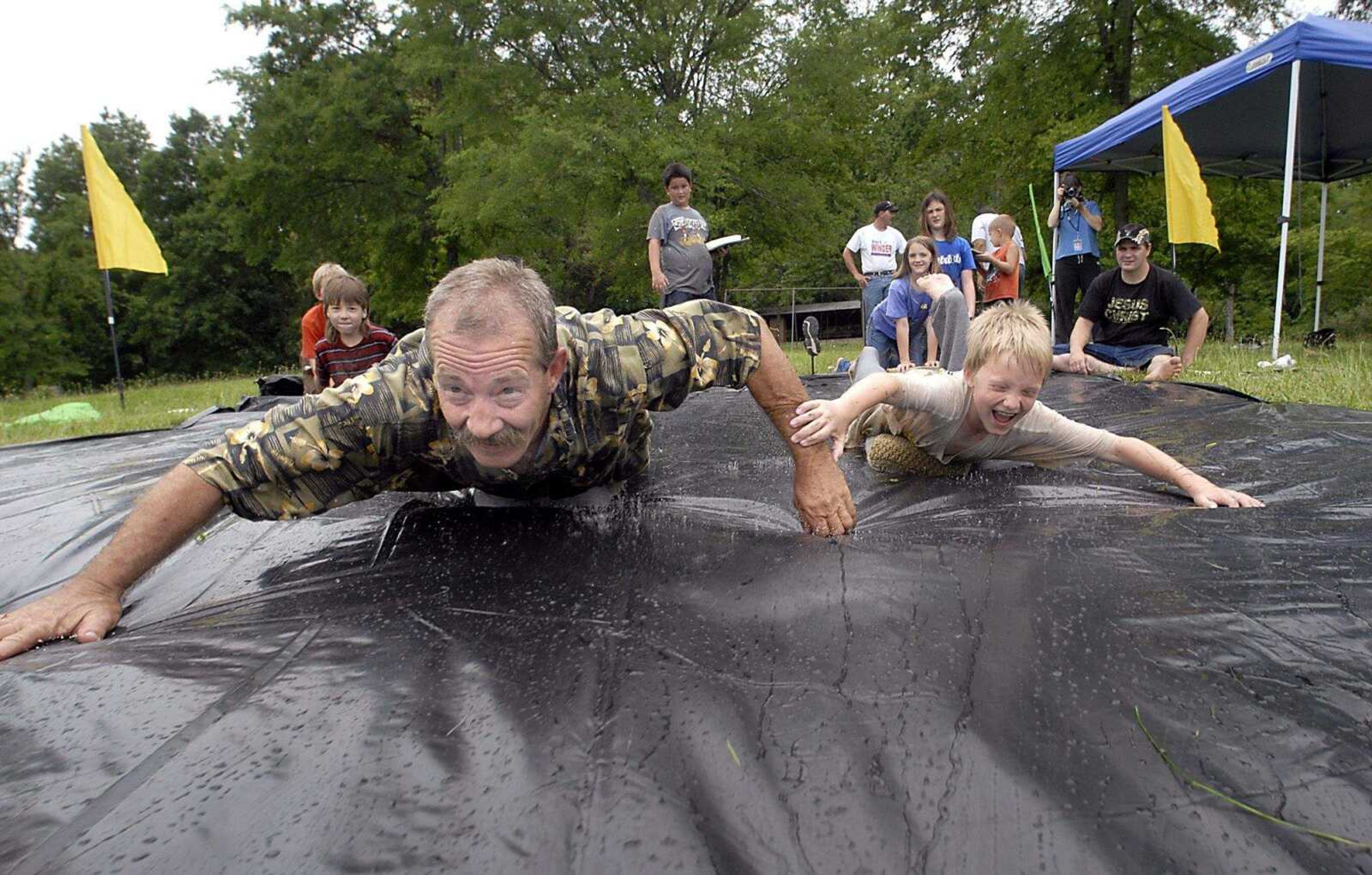 KIT DOYLE ~ kdoyle@semissourian.com
Jack Watt, left, raced Landon Thomsen, 9, down a hill Saturday, June 28, 2008, on ice blocks at Pellegrino Park in Marble Hill. It was the second annual ice block races.