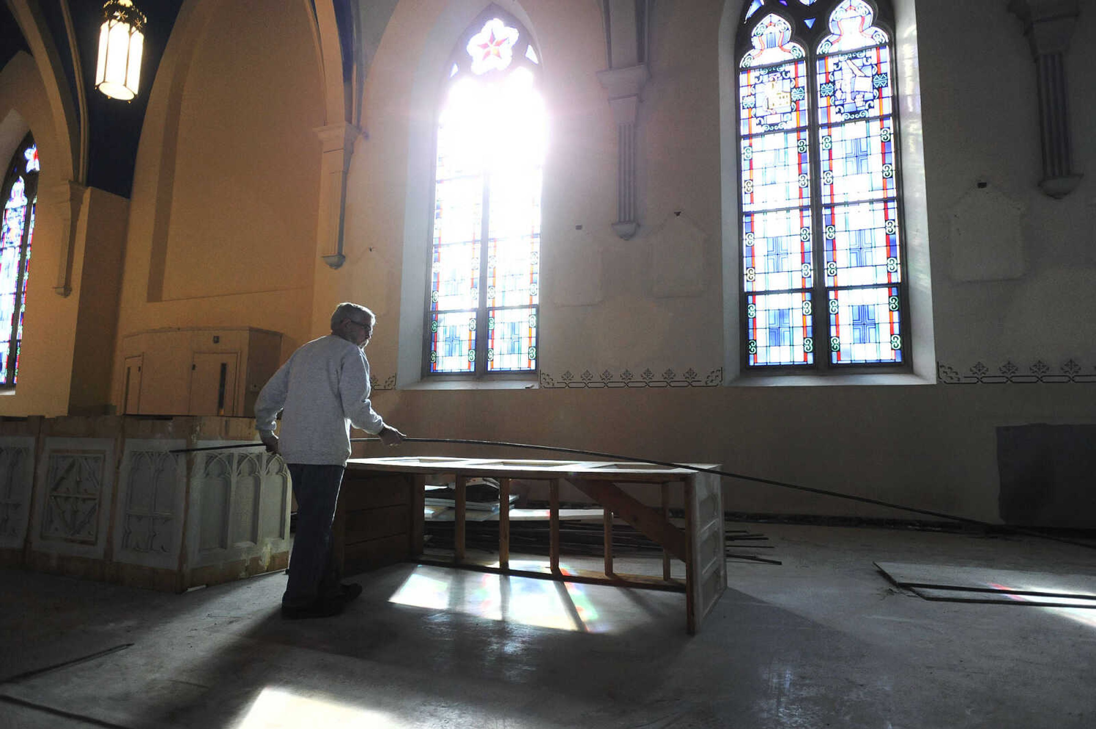 LAURA SIMON ~ lsimon@semissourian.com

Nick Elfrink measures the length of an altar inside St. John's Catholic Church in Leopold, Missouri on Feb. 11, 2016. Elfrink and his wife Geri repaired and painted the altars inside the church. .