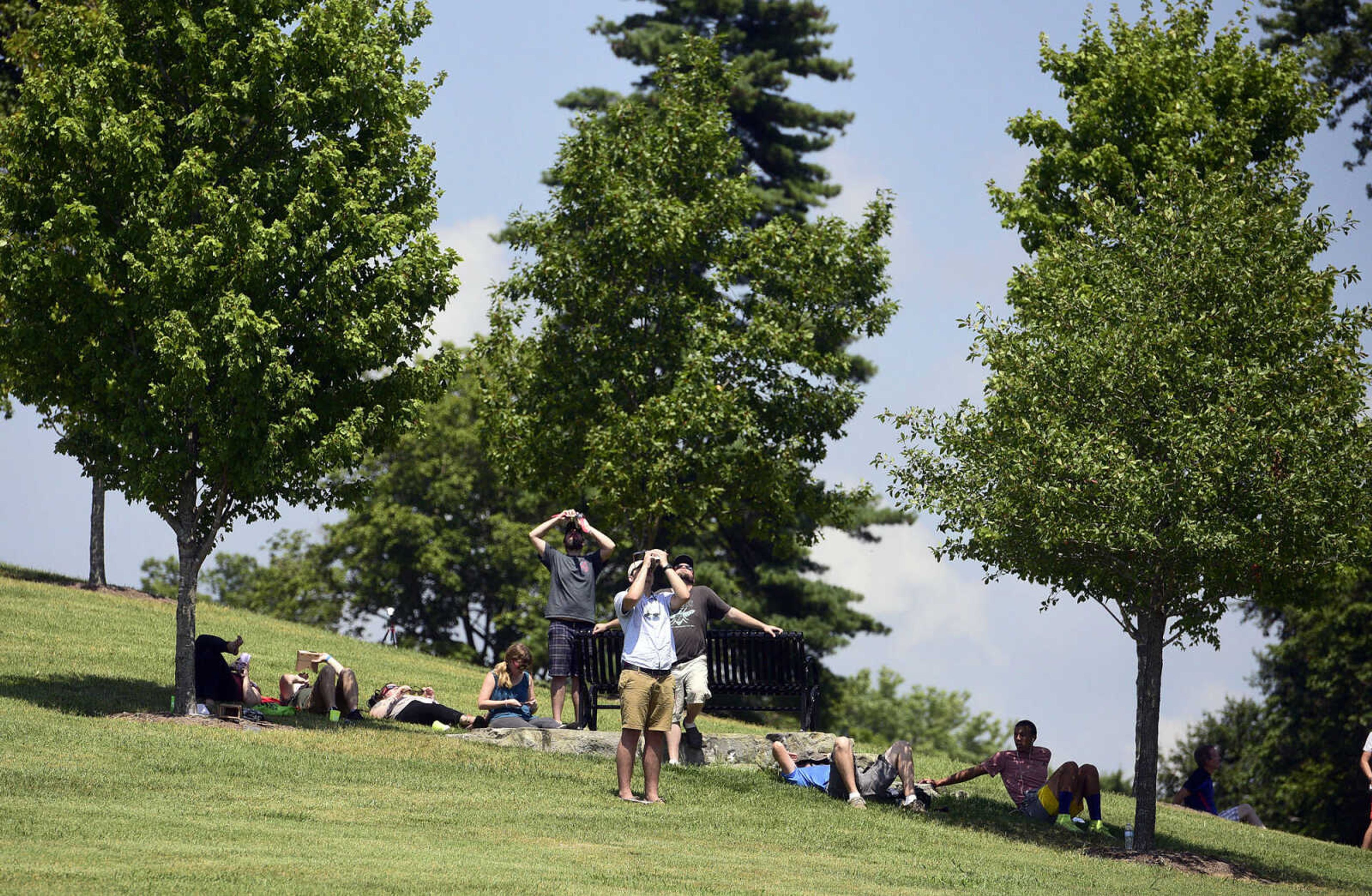 Visitors watch the stages of the solar eclipse on Monday, Aug. 21, 2017, from the River Campus in Cape Girardeau.