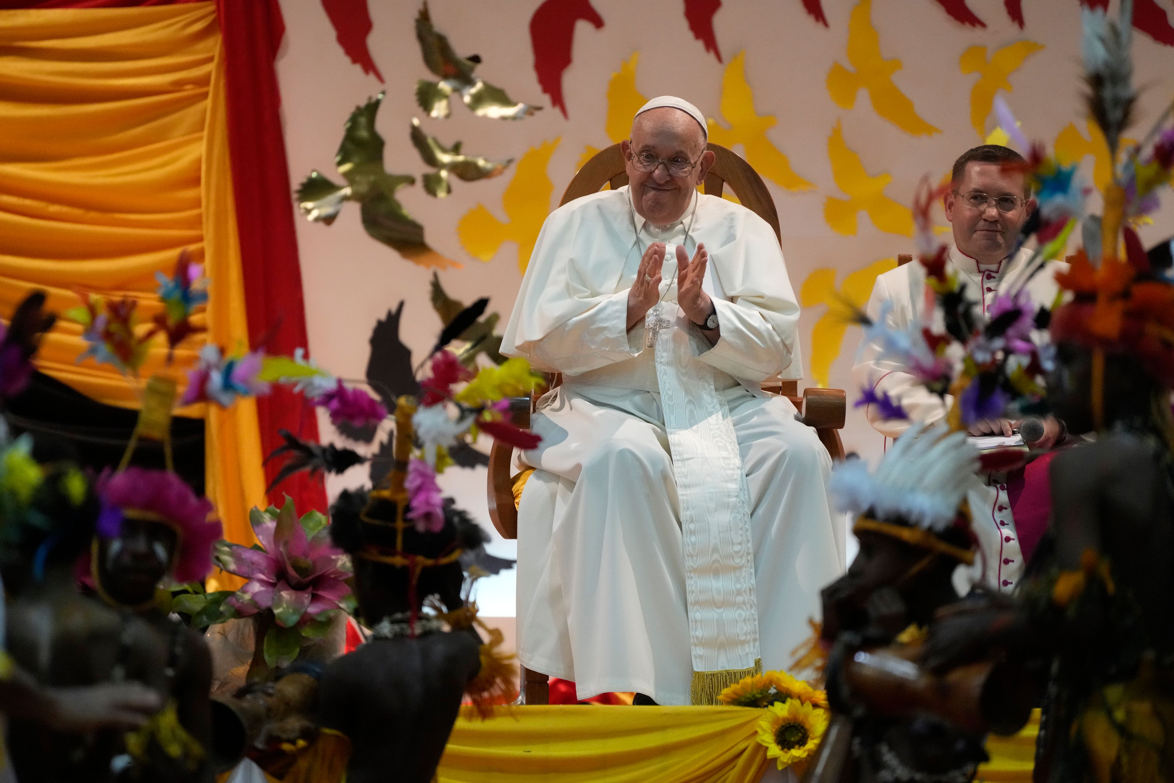 Pope Francis, left, attends a traditional dance performed by the Caritas Technical Secondary School pupils in Port Moresby, Saturday, Sept. 7, 2024. (AP Photo/Gregorio Borgia)