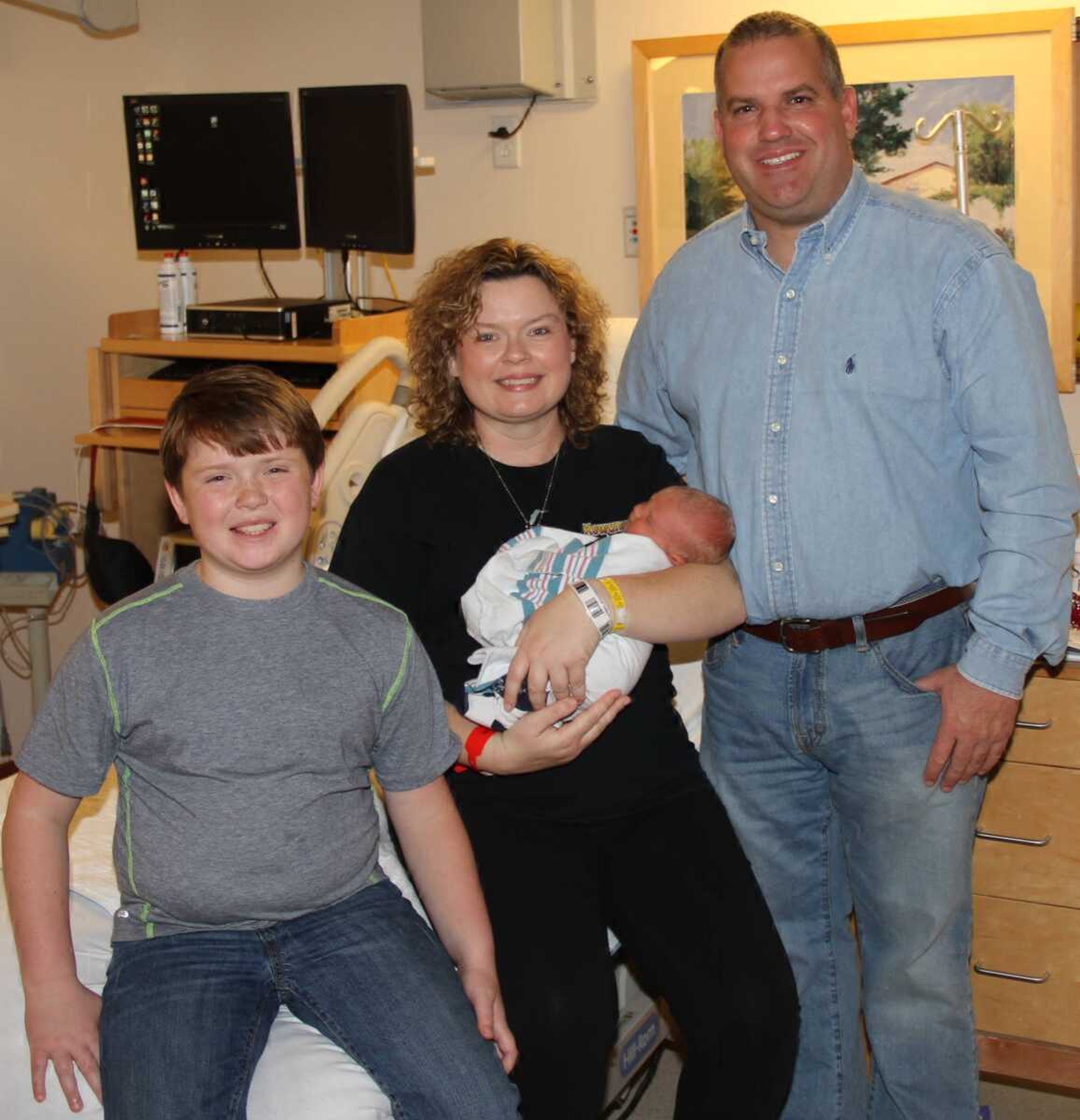 Jason and Christina Taylor of Lilbourn, Mo., celebrate the birth of their son, John Luke, with their other son, 9-year-old Noah, at Southeast Hospital. The birth marked the 1,000th delivery at Southeast Hospital this year.