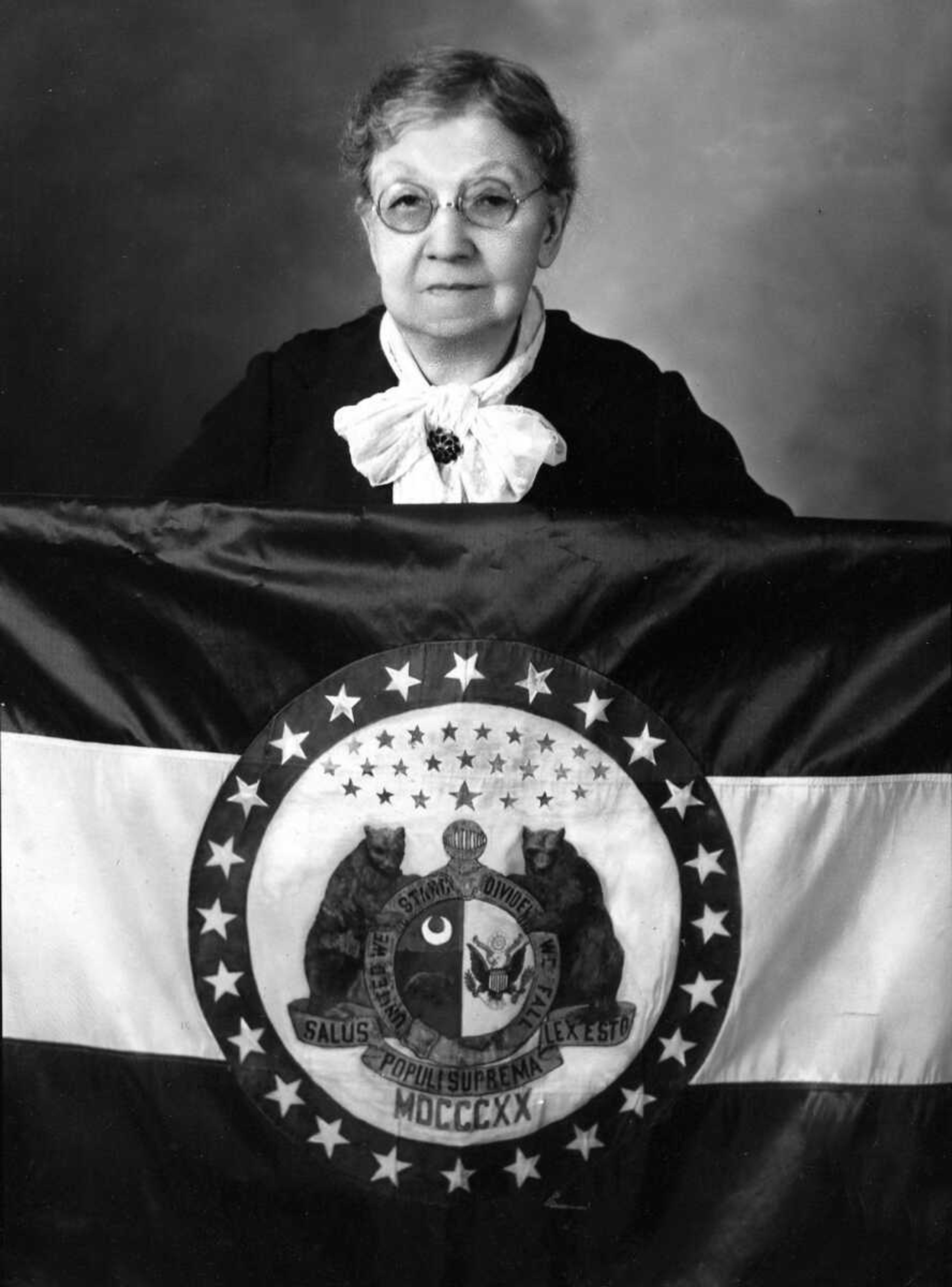 Marie Elizabeth Watkins Oliver holding the Missouri state flag she designed.