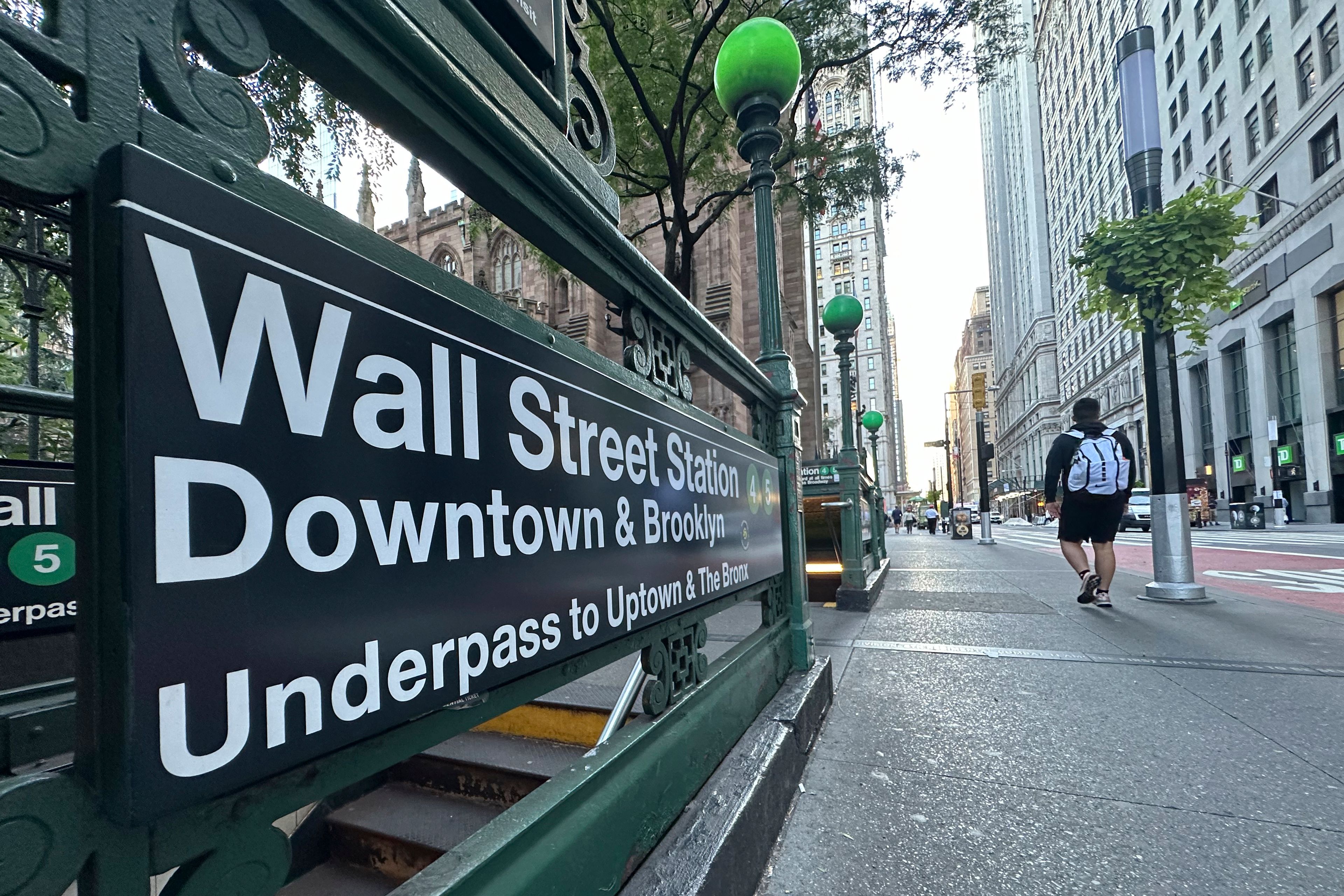 FILE - People pass the entrance for the Wall Street subway station on Sept. 2, 2024, in New York. (AP Photo/Peter Morgan, File)