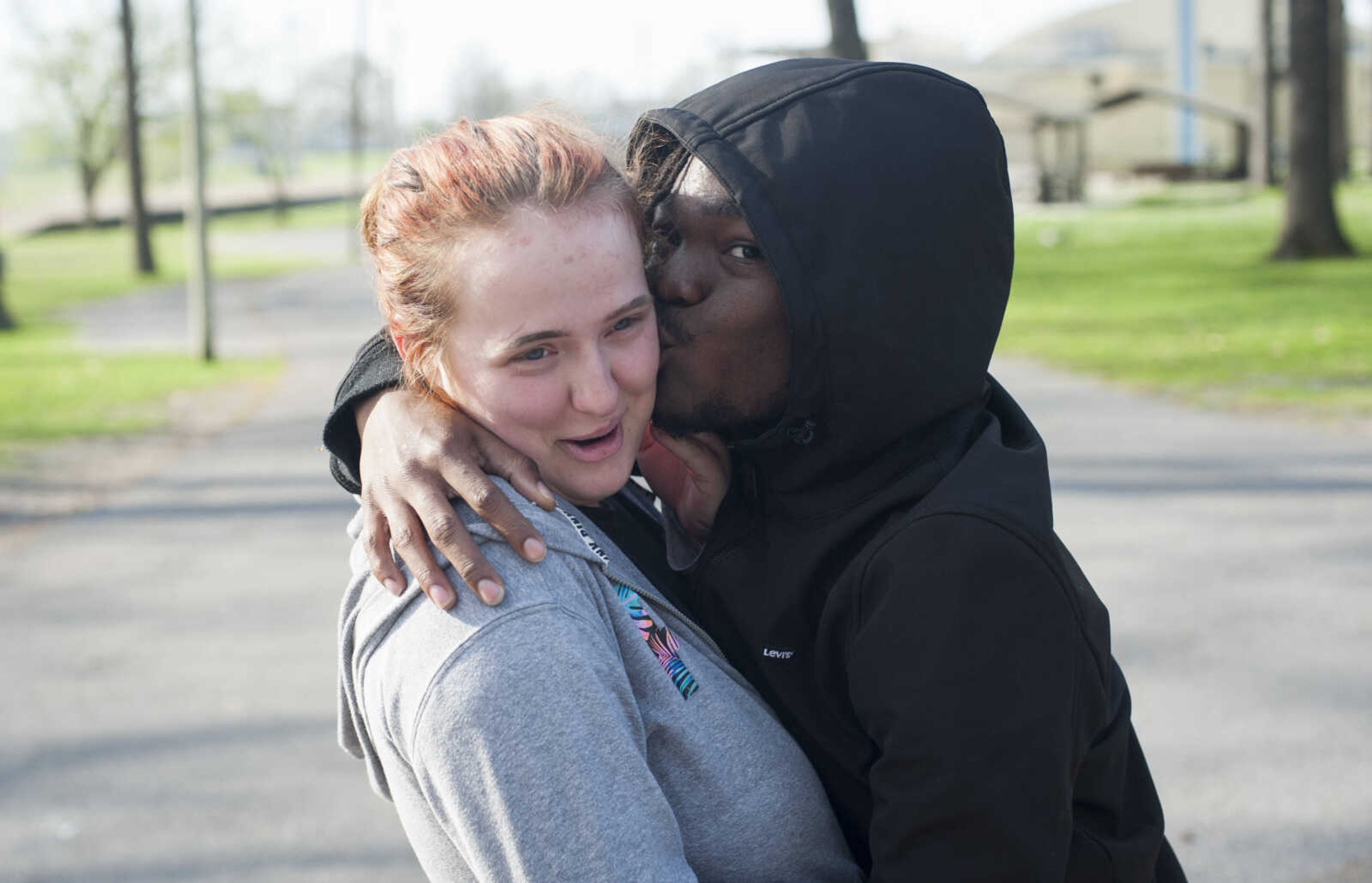 Bobby Spencer surprises Kadence Lawrence with a kiss on the cheek while walking through Arena Park on Thursday, April 2, 2020, as Cape Girardeau Parks and Recreation crews close playgrounds and basketball courts in the area due to COVID-19.