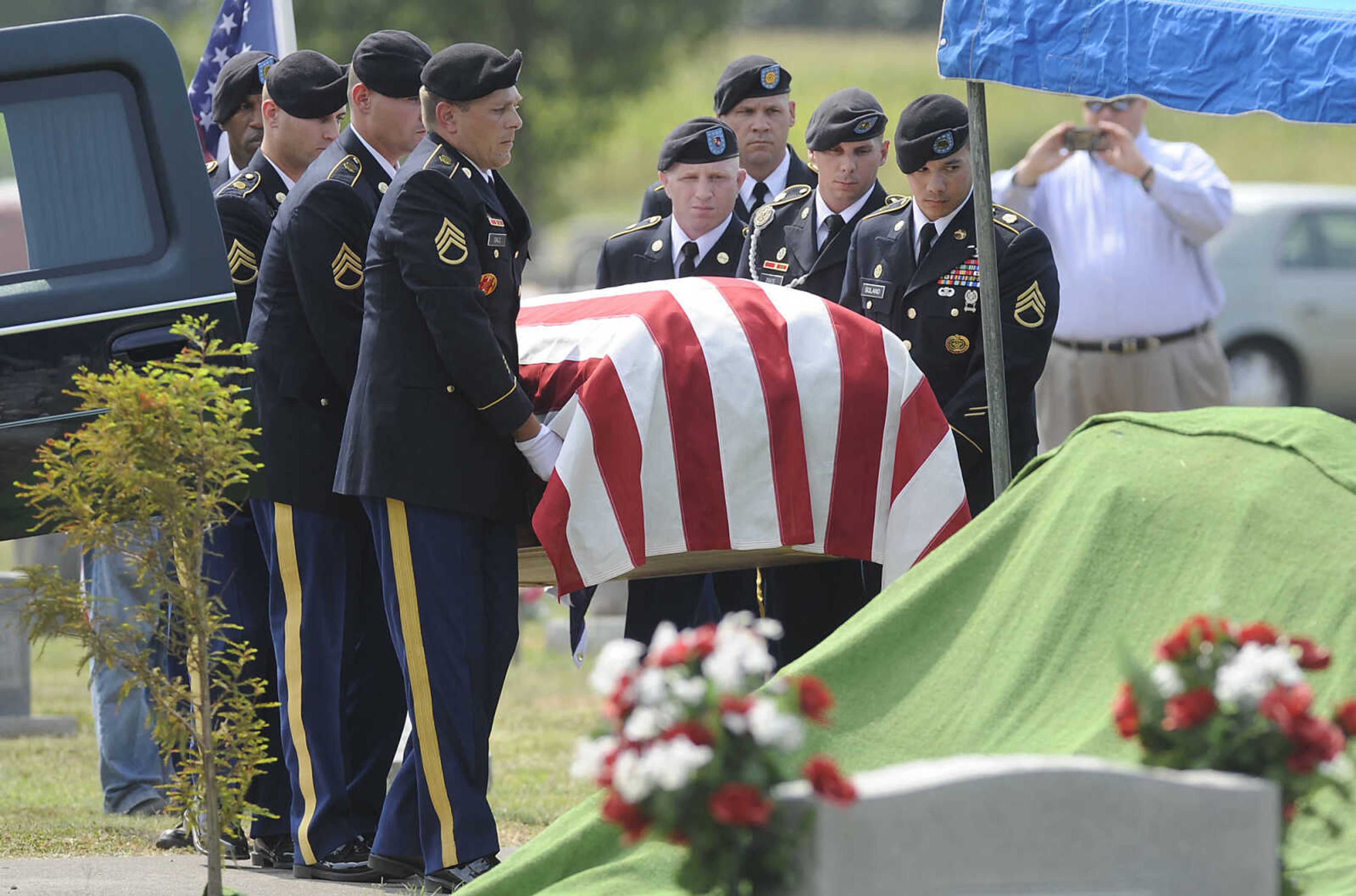 An honor guard carries U.S. Army Air Forces 1st Lt. Warren G. Moxley to his grave Tuesday, July 3, at the Odd Fellows Cemetery in Charleston, Mo. A pilot with the 67th Tactical Recon Group's 107th Observation Squadron Moxley was killed on March 15, 1945, when his F6, a photo-reconnaissance model of the P-51 Mustang, was shot down over Germany by anti-aircraft fire. His remains were identified using DNA earlier this year.